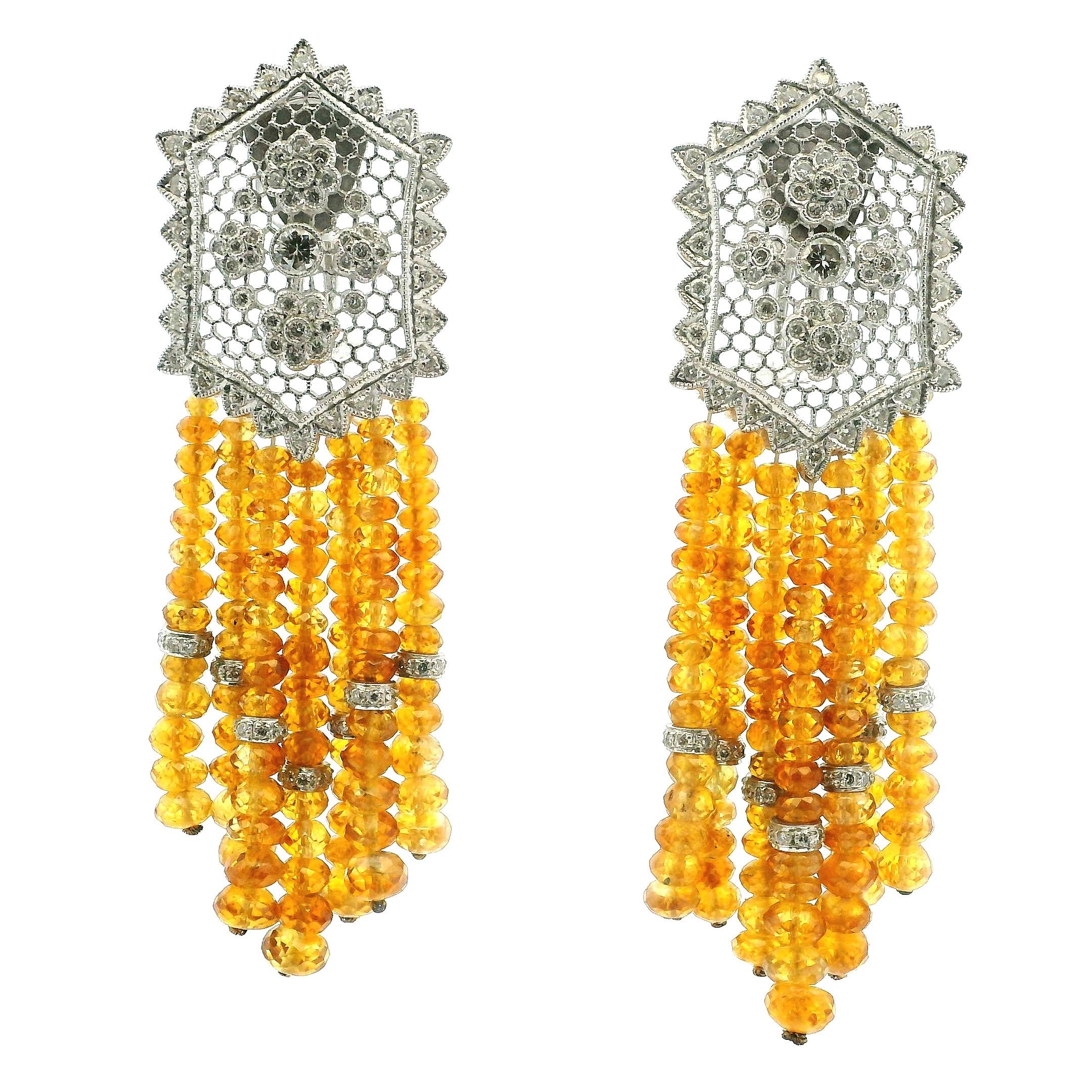 Uno straordinario paio di orecchini con nappe in oro bianco 18 carati degli anni '80-'90, che mostrano l'esuberante glamour e la raffinata maestria del design dell'alta gioielleria della fine del XX secolo.
Ogni orecchino presenta una placca