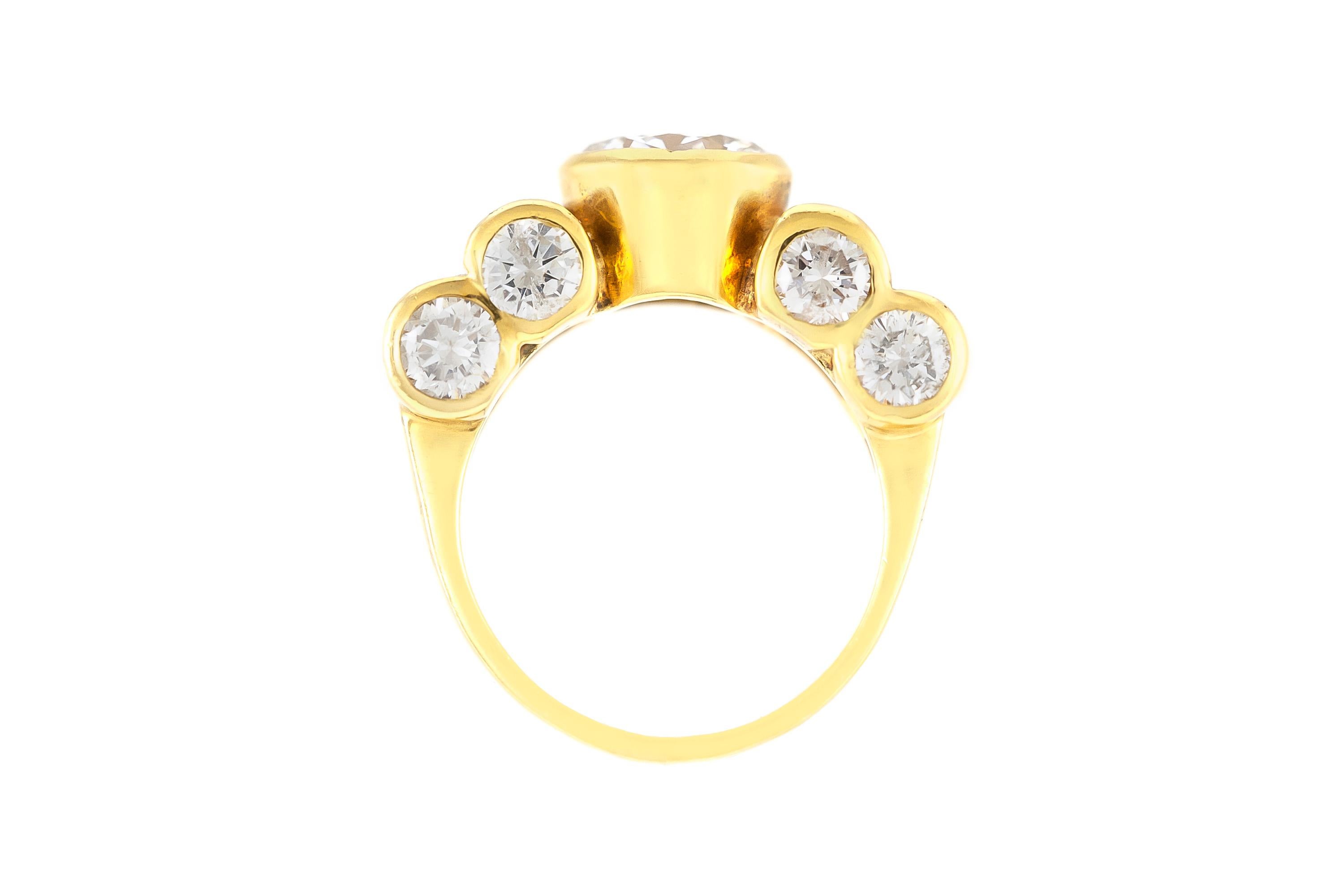 The ring is finely crafted in 18k yellow gold with center round diamond weighing approximately total of 1.41.
Color G    Clarity VS2 .
With rounds and baguettes diamonds weighing approximately total of 3.50 carat.
Circa 1980.
