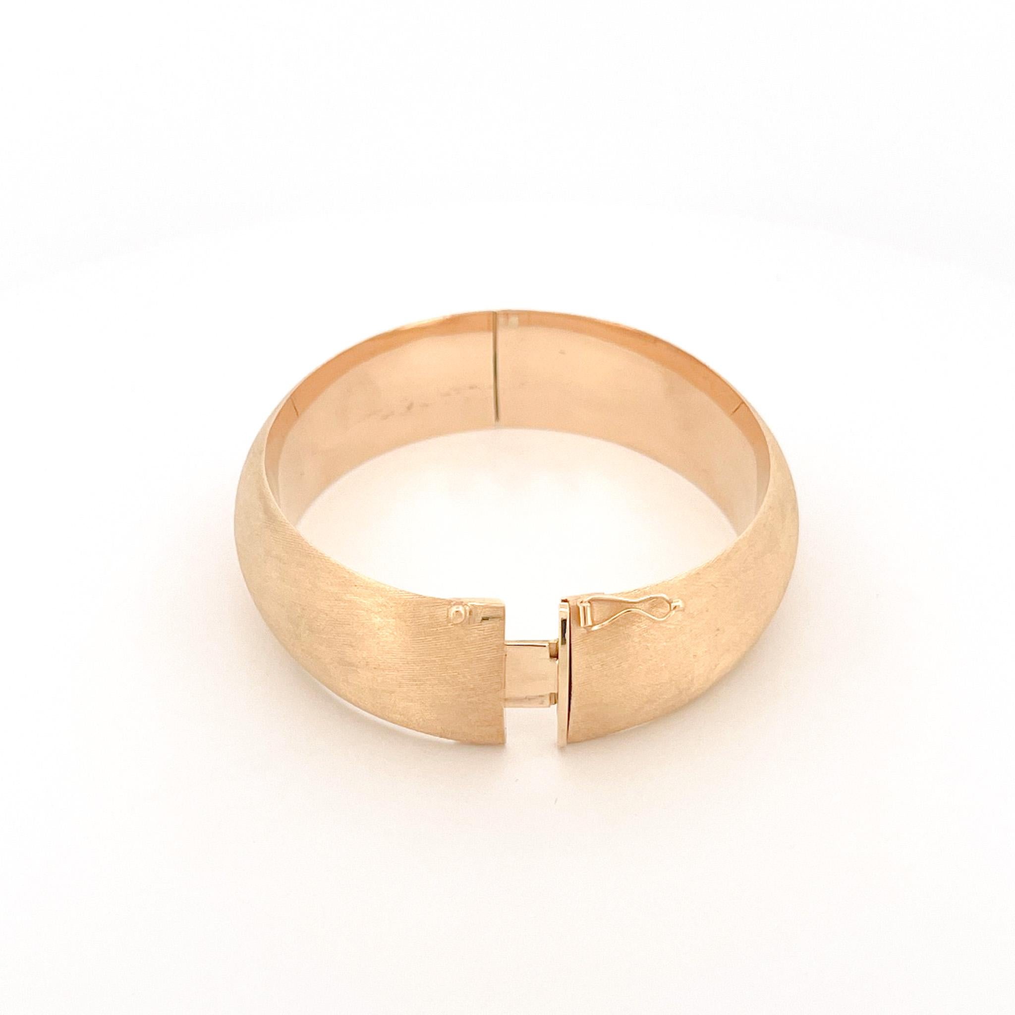 From the Eiseman Estate Jewelry Collection, circa 1980s, 18 karat yellow gold thick bangle featuring a Florentine finish. This bangle measures 5mm wide and fits a wrist size 7 to 7.5 inches.