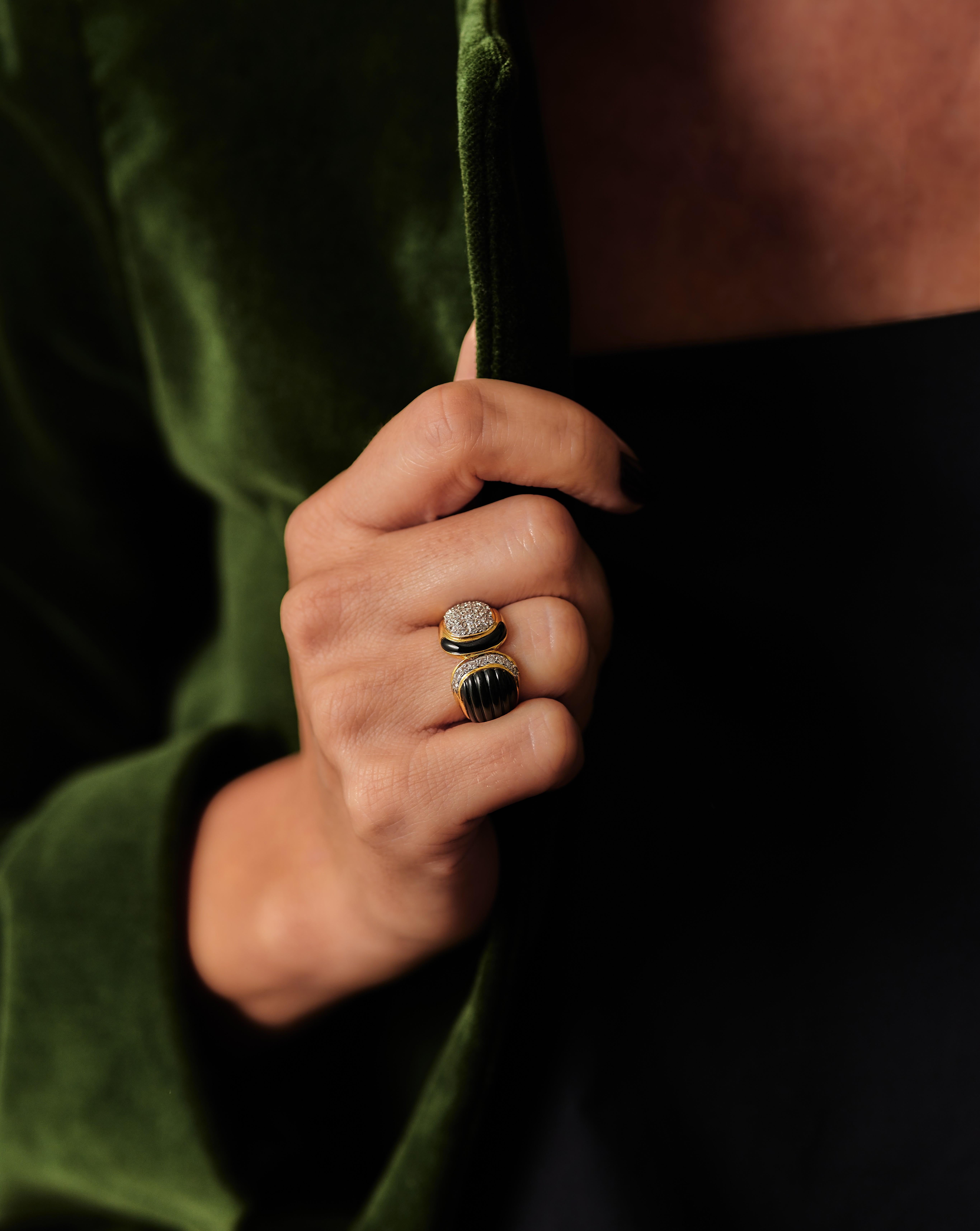 Anello in oro 18kt con onice e diamanti degli anni '80/'90.
Progettato come due lati opposti. Luce contro buio. Yang/Yang. Da un lato abbiamo un pezzo di onice tagliato e curvo con accenti di diamanti, dall'altro 36 diamanti taglio brillante con