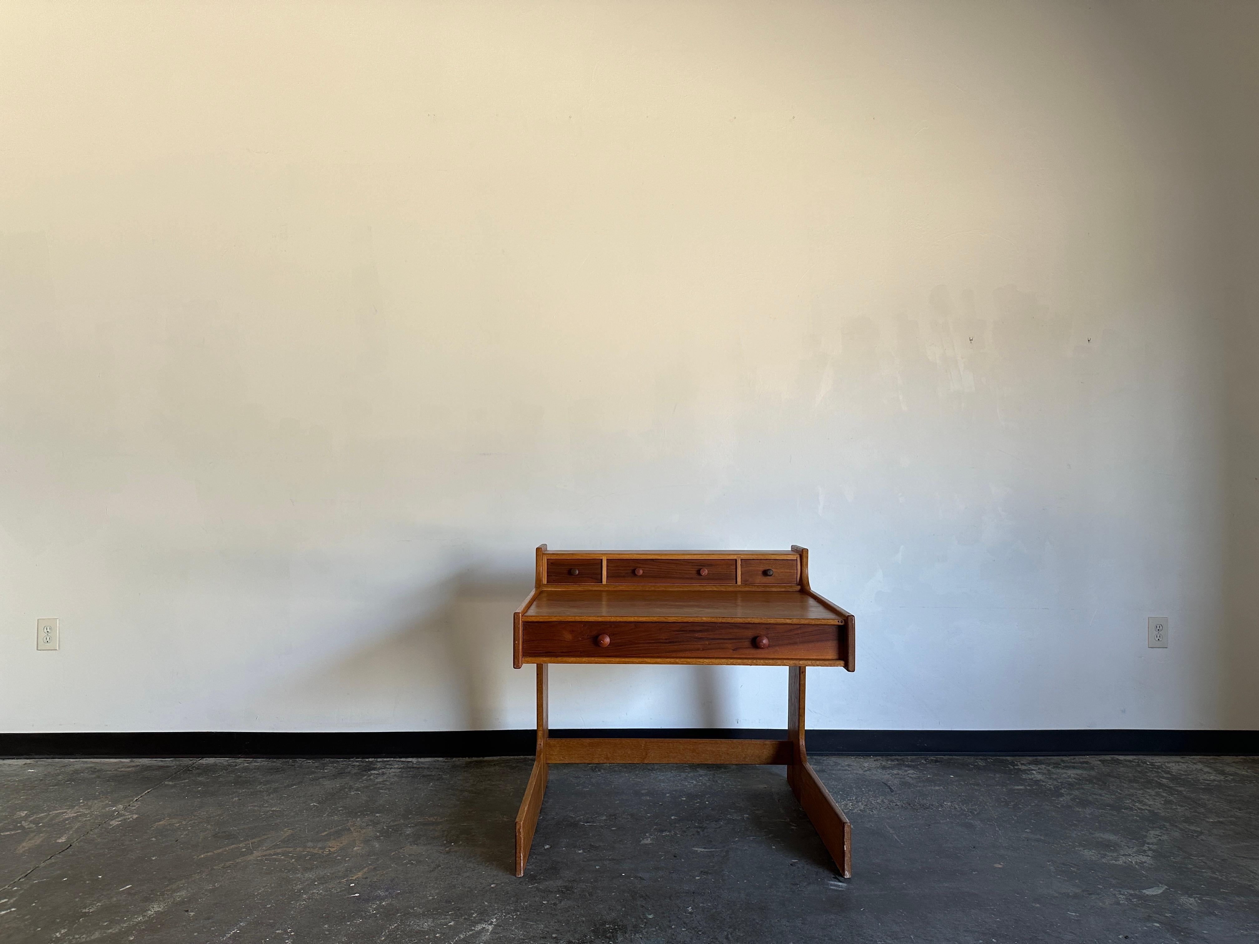 Cantilevered wood desk with drawers in excellent vintage condition. A very versatile piece. Extremely sturdy with a substantial weight.

Floor to highest point: 34.5”
Floor to top of back: 33.5”
Width: 36”
Depth: 32:
Floor to top of drawer: