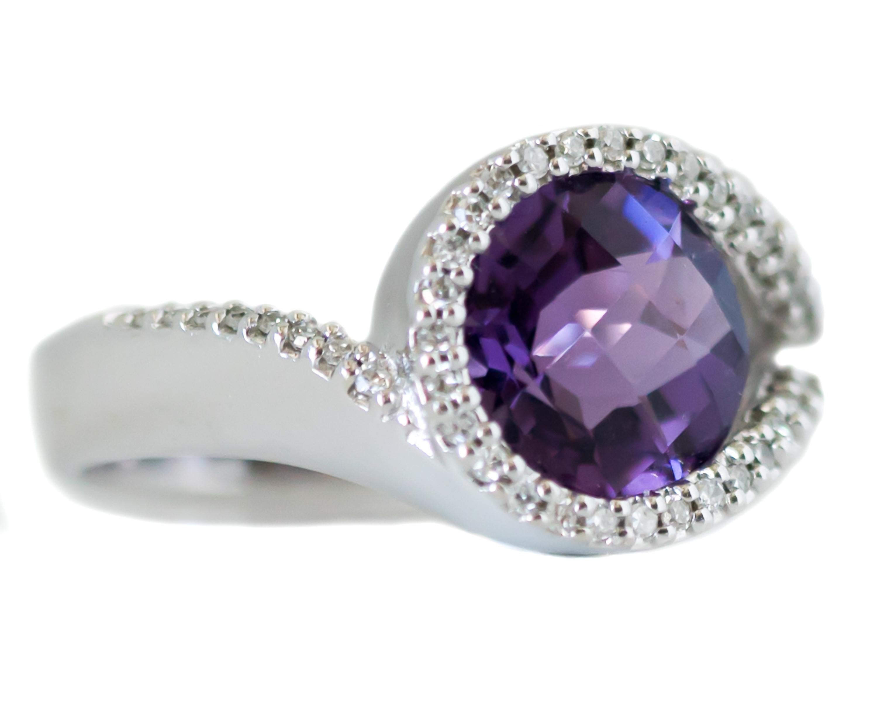 1980s Round Amethyst Ring - 14 Karat White Gold, Purple Amethyst, Diamonds

Features:
2.0 carat Checkerboard cut Round Purple Amethyst center stone
0.50 carat total Single cut Diamond modified Halo and Shoulders
Modified Bypass setting
14 Karat