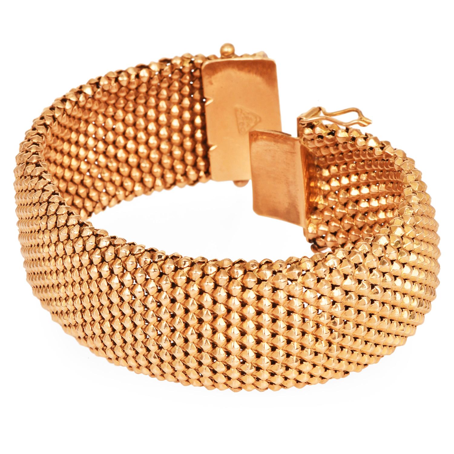 Timeless in design and luxurious in execution, this estate bracelet showcases a beautifully woven, braided mesh pattern that offers both visual interest and a supple, fluid feel. Expertly crafted in solid 18K yellow gold, the bracelet drapes