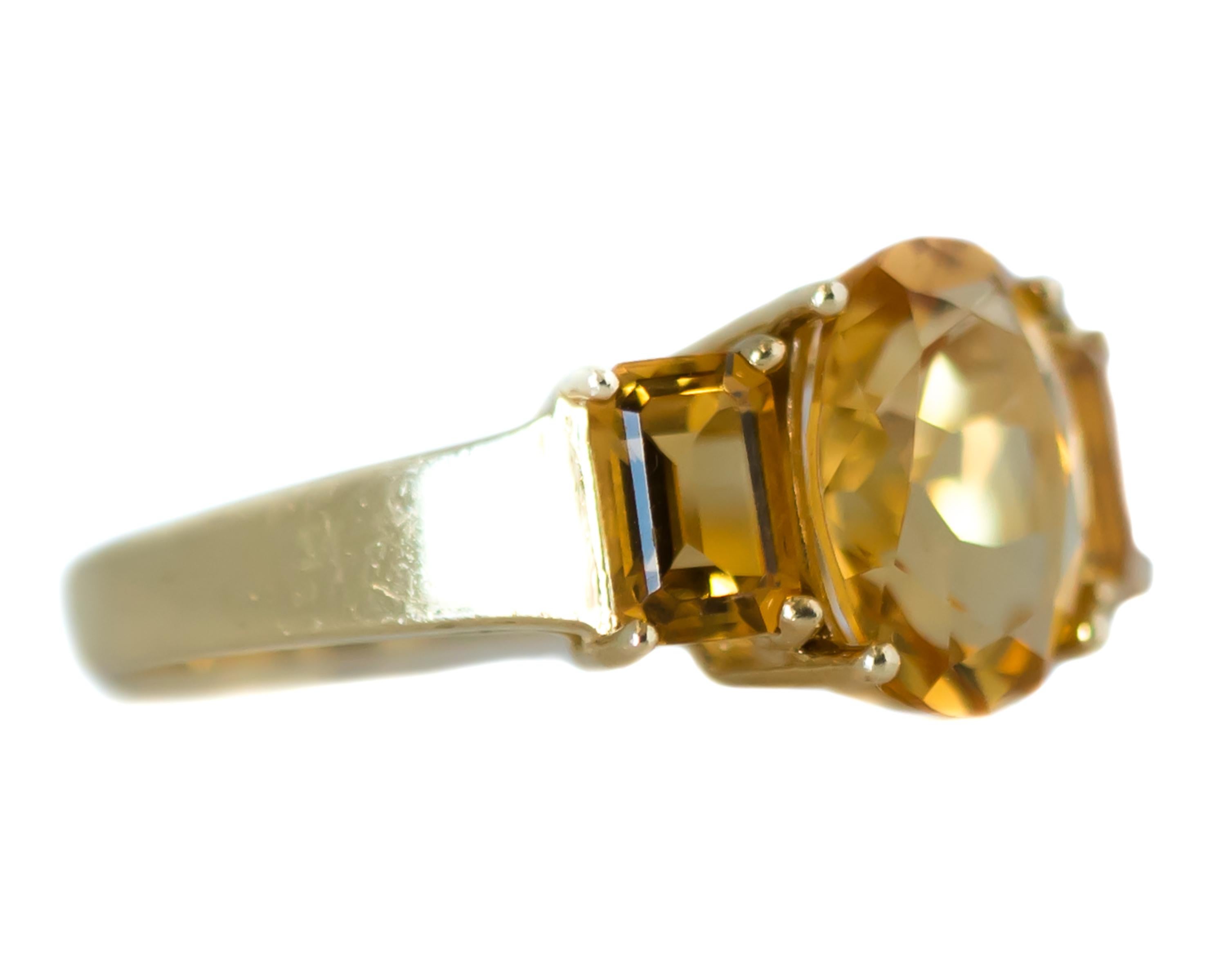 1980s Three-Stone Citrine Ring - 14 Karat Yellow Gold, Citrine

Features: 
4.9 carat total Citrine
Oval cut Citrine center stone
Baguette cut Citrine side stones
14 Karat Yellow Gold Cathedral Setting
Prong Set Stones
Open Gallery and