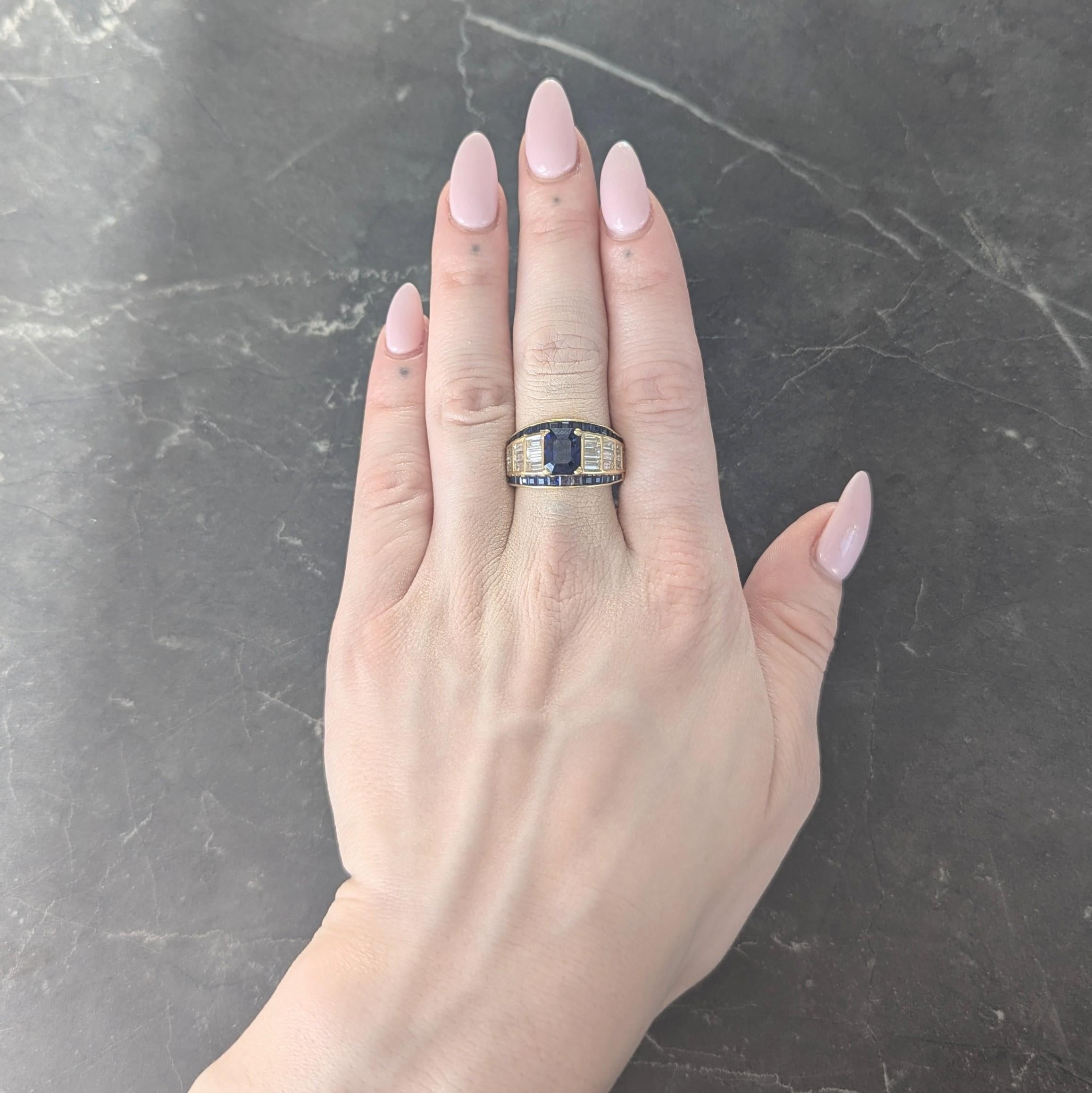 Centering an emerald cut sapphire weighing approximately 3.02 carats - transparent deep blue in color
Prong set and flanked east to west by tapered rows of channel baguette cut diamonds
Weighing approximately 0.80 carats total - G/H color with VS2