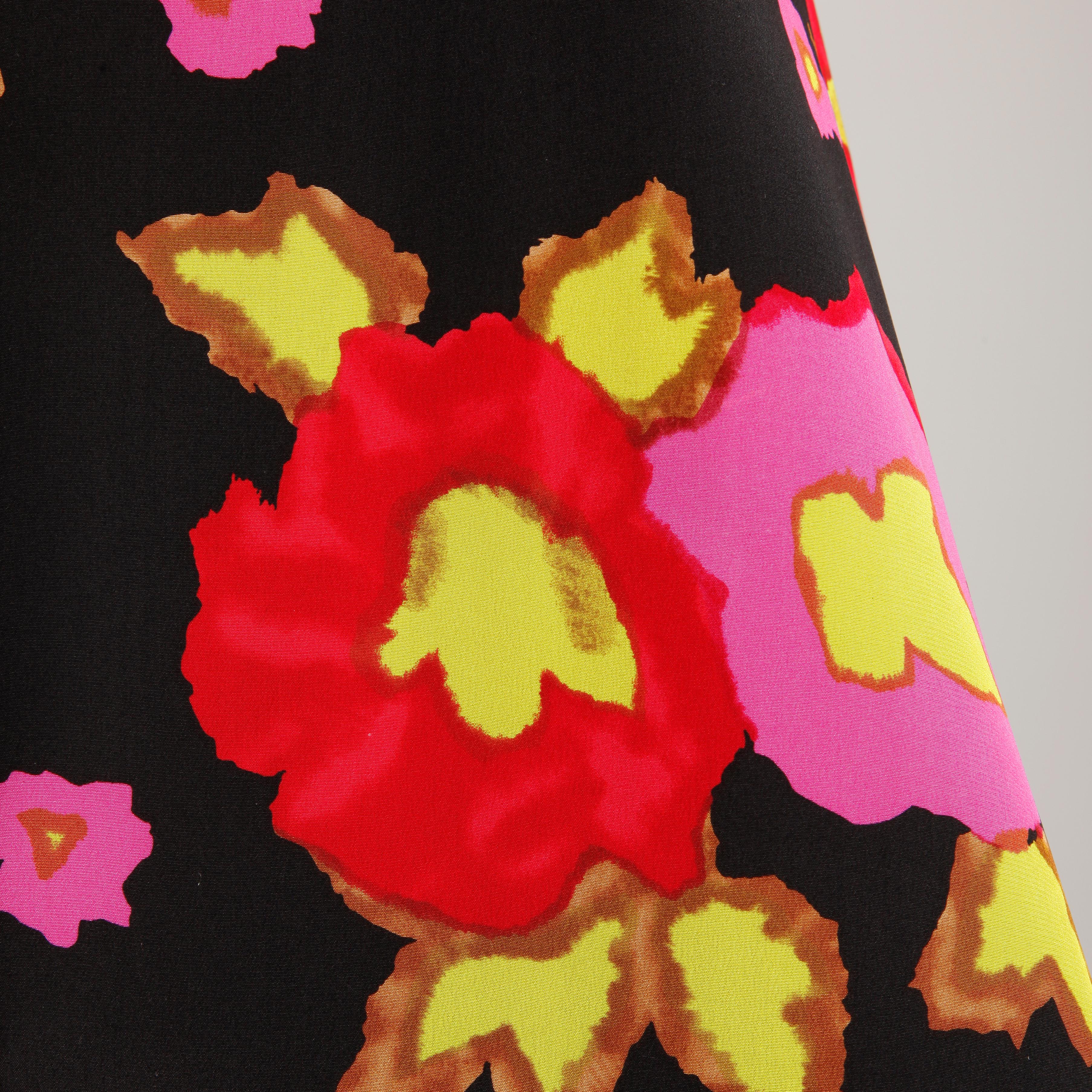 Darling vintage Arnold Scaasi silk dress in a vibrant floral print. Fully lined with rear zip and hook closure and a structured front box pleat. 100% silk with 100% acetate lining. The marked size is 6, and the dress fits true to size. The bust