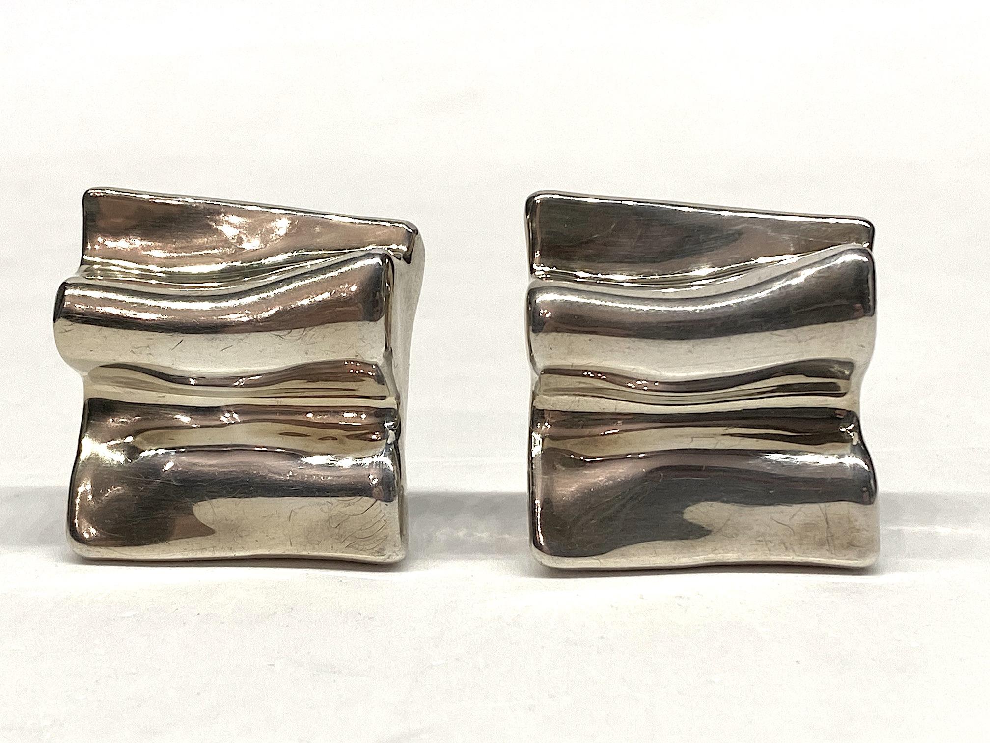 A wonderful and sculptural pair of abstract sterling silver square button earrings. Each measures 1.38 inches wide, 1.5 inches tall and .5 of an inch deep not including the clip back. The earrings are made in the electroform method. First a model is