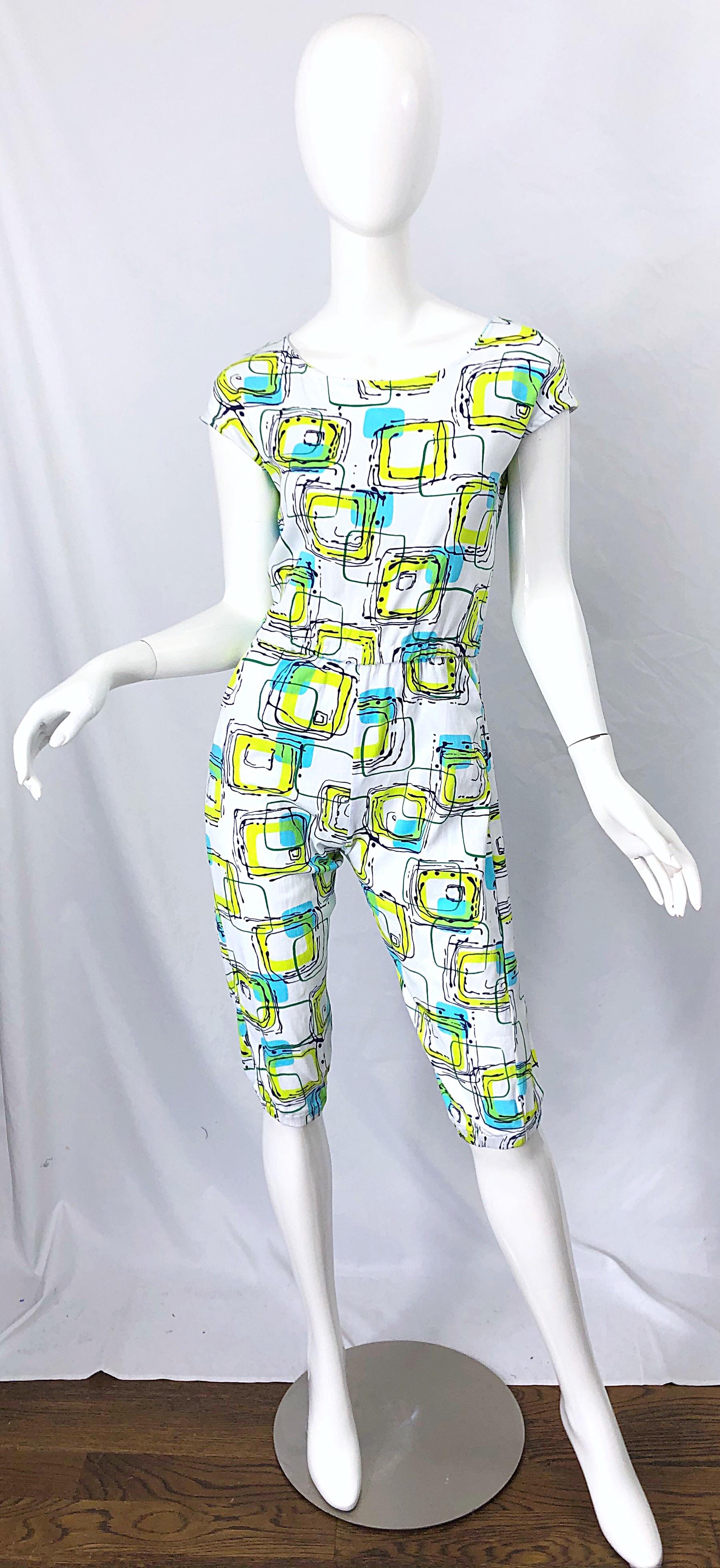 Amazing 1980s abstract square print neon blue and green cap sleeve romper jumpsuit ! Features vibrant colors of turquoise blue, neon yellow green and black on a white backdrop. POCKETS at each side of the hips. Button closure at top center neck.