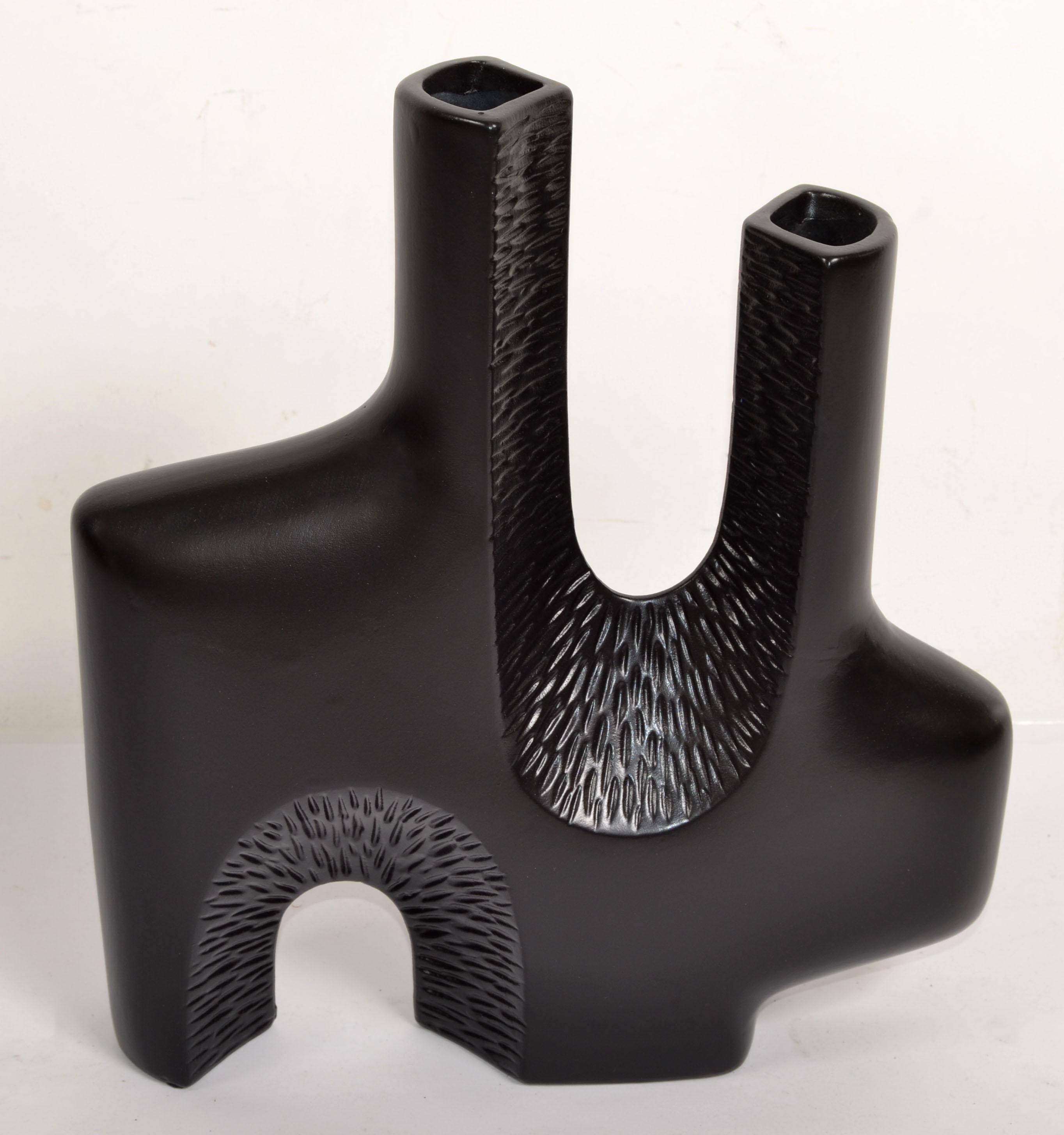 1980s Organic Modern textured Ceramic Vase Studio Piece in matte black finish in the Style of Valentine Schlegel.
A two neck Vessel for Flowers, Ferns or Silk Flower Decoration.
Great Craftsmanship to display on Top of a Fireplace, Sideboard,