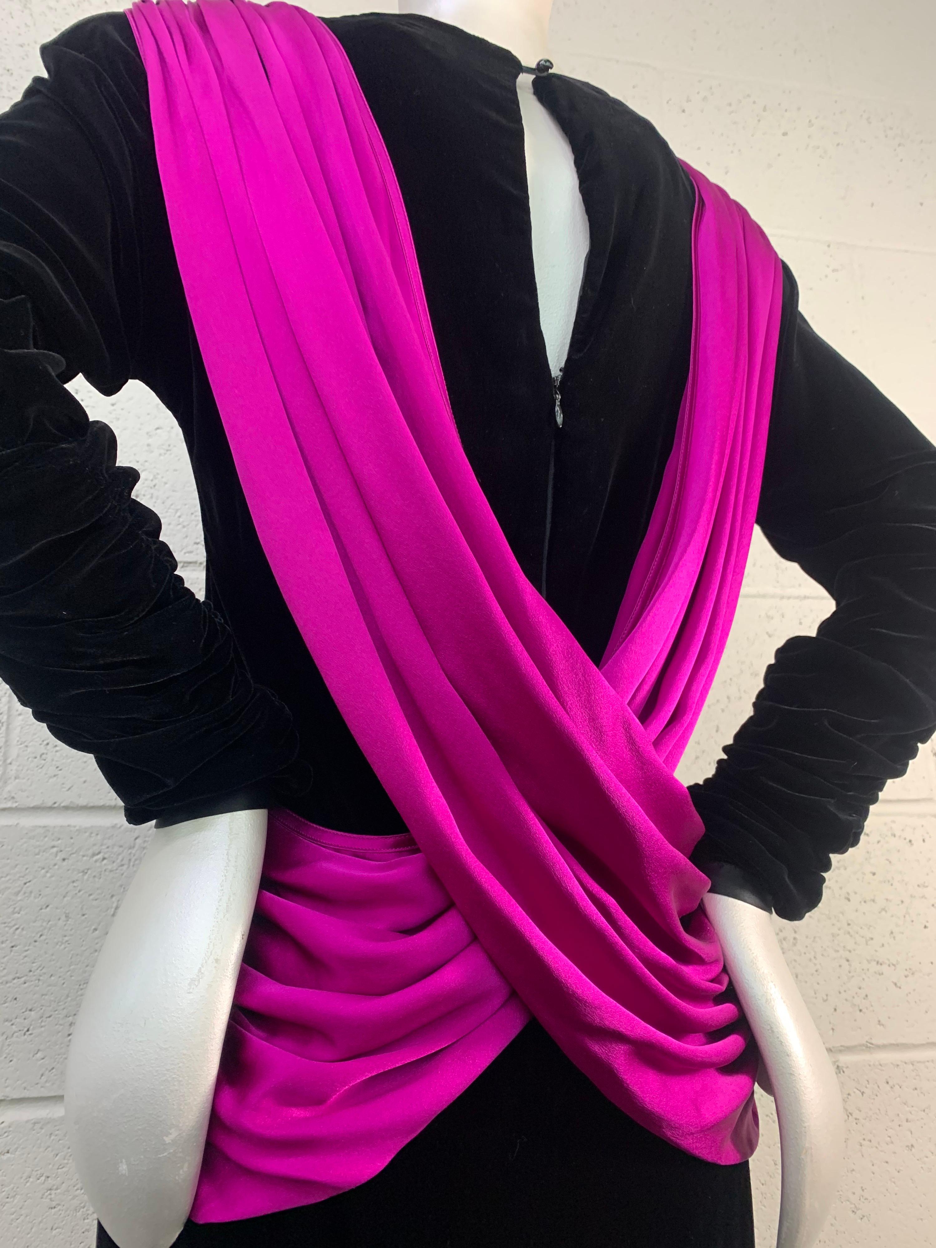 A striking 1980s Adam Beall 40s-inspired cocktail dress in black velvet with a strong shoulder silhouette and a vivid fuchsia X-draped silk charmeuse back. US size 6. Long-sleeved with back zipper and keyhole back closure. 