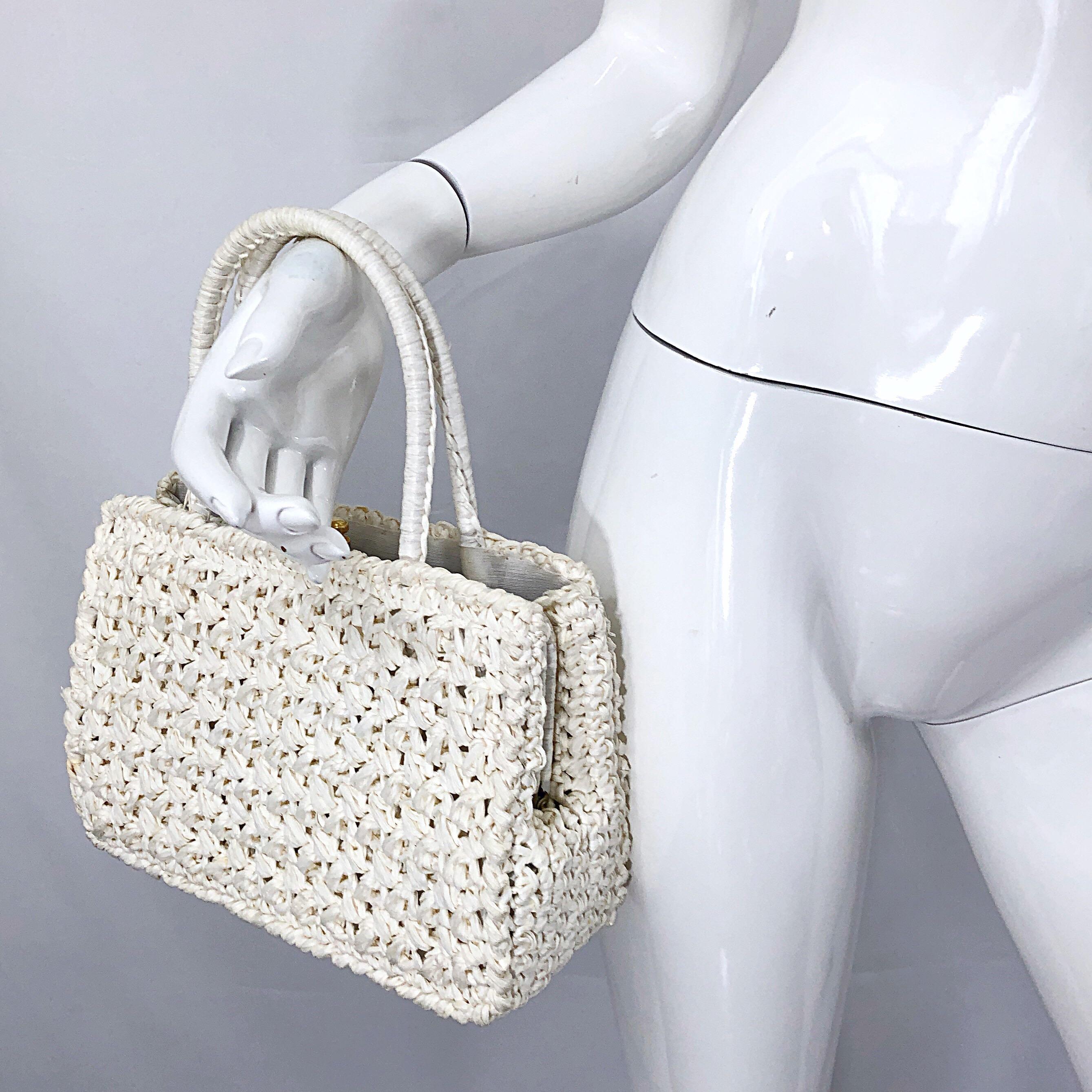 Pretty early 1980s ADORIA Italian Made stark white raffia straw satchel handbag! Features soft white raffia, with secured center pocket that snaps shut. The perfect spring / summer accessory for any outfit. In excellent condition, with not signs of