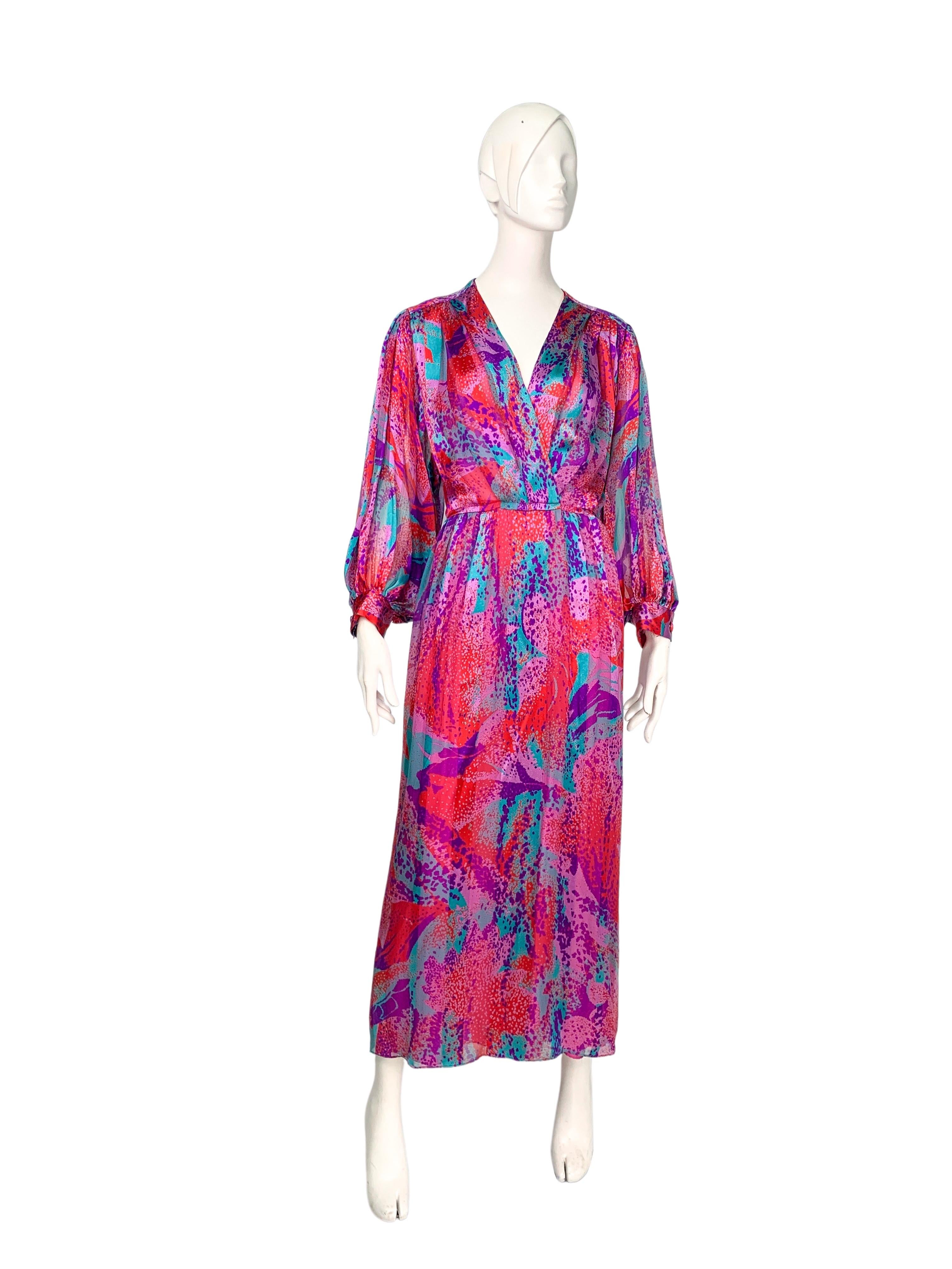 By Akris, a luxury fashion brand from Switzerland, a vintage 1980s silk maxi dress with an all-over abstract print in shades of pink, red, purple, and teal. Features opulently wide kimono-style long sleeves and a wrap-around V-neck bodice.
Excellent