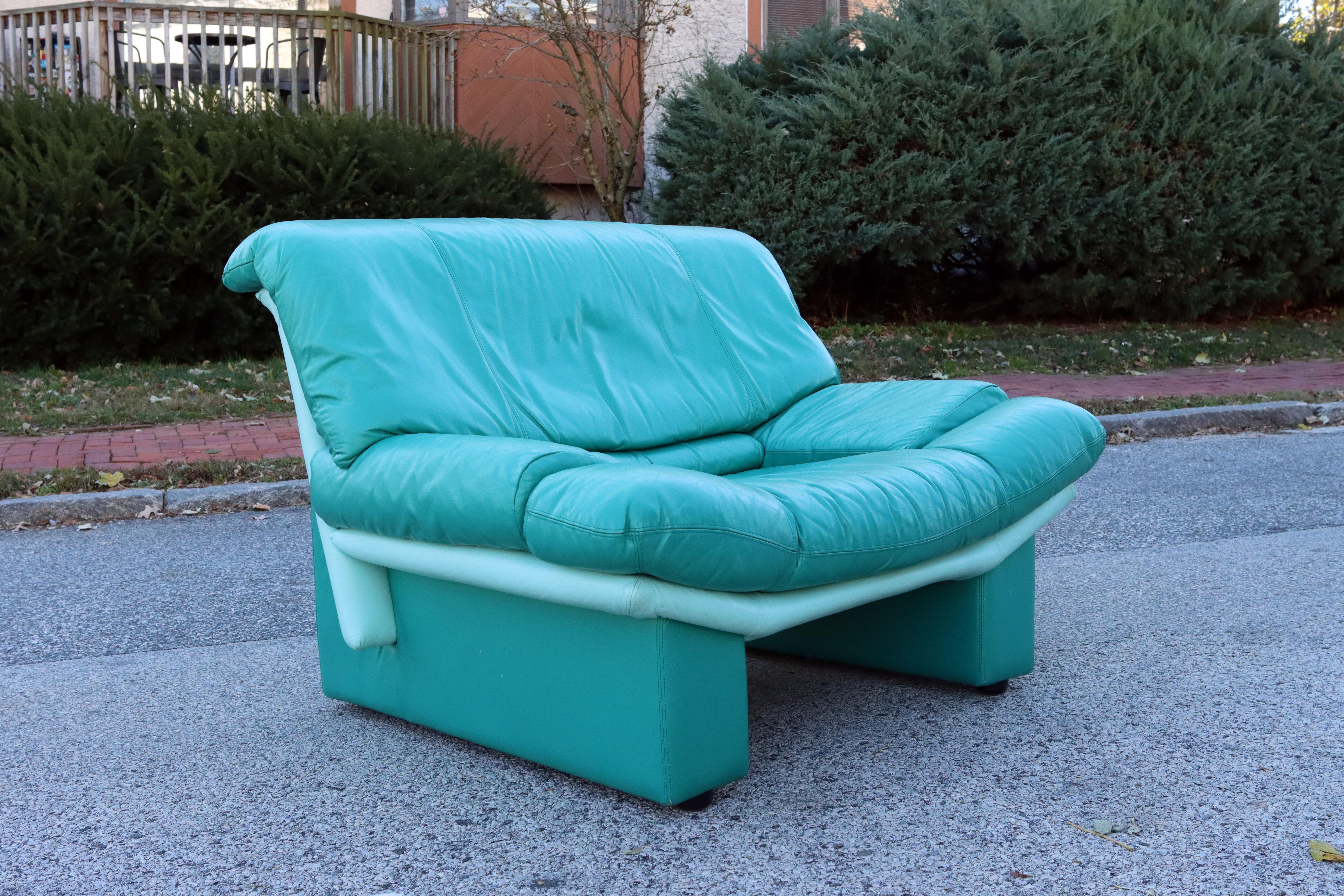 A vintage Alpa Salotti club chair upholstered in vibrant teal leather. A brilliant pop of color to liven up your space. The leather is in excellent condition with no significant damage or wear. No dryness, cracking, or tears. Interior foam is soft.
