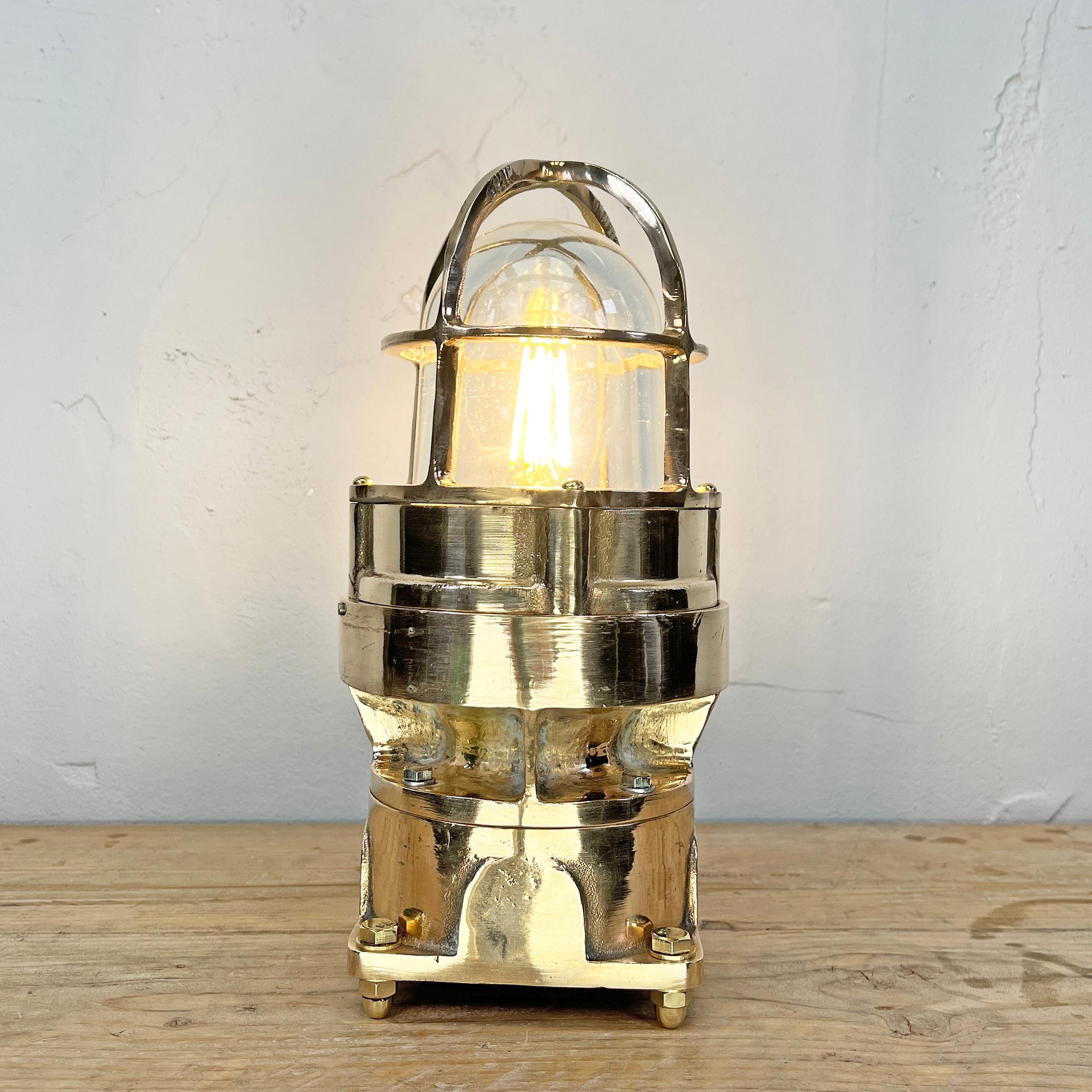 A robust bronze industrial outdoor light reclaimed from decommissioned cargo ships and adapted for decorative use. This is a vintage industrial lamp is made by the American company Pauluhn Electric Manufacturing. We have professionally restored this