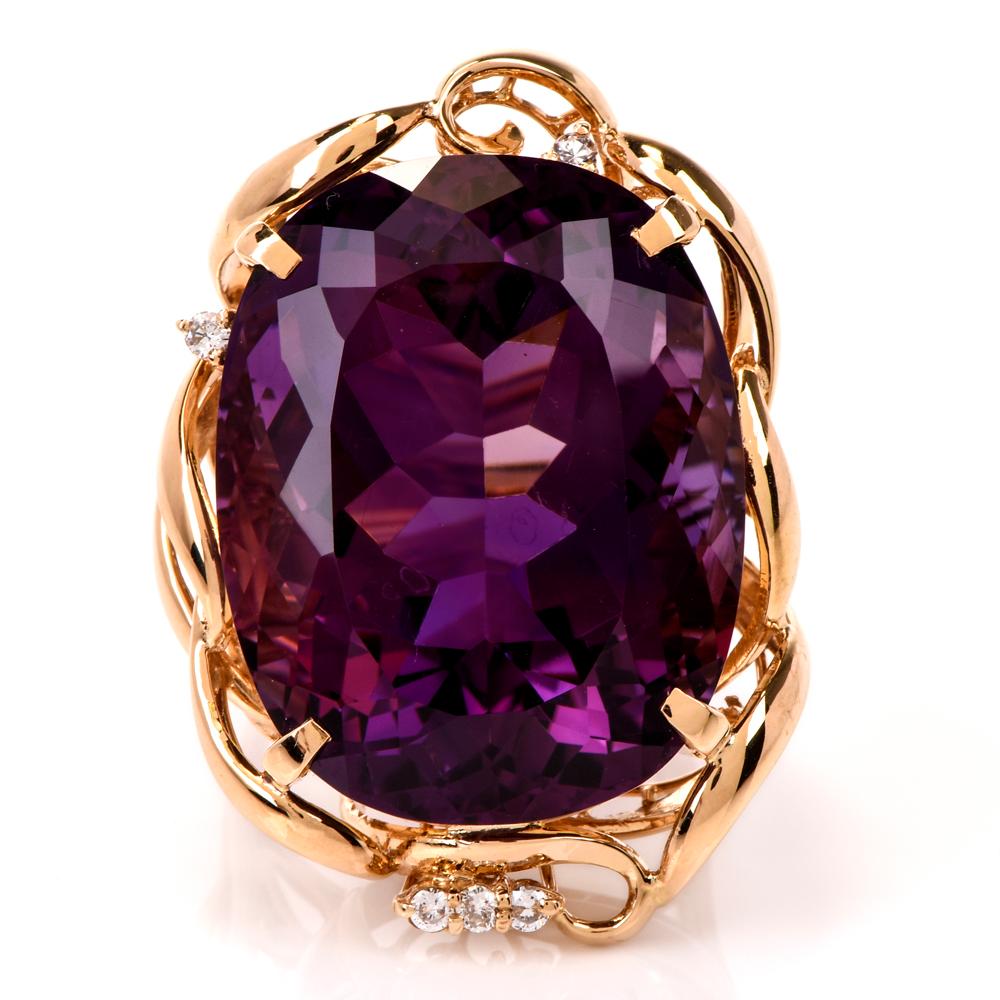 This extravagant amethyst cocktail ring is crafted in 18 karat yellow gold. Displaying an extraordinary swirl design frame with a prong-set amethyst weighing approx. 46.73 carat. Embellished by round-cut diamonds weighing approx. 0.10 carats, graded