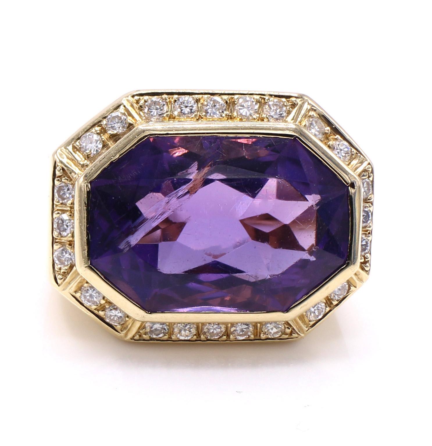 Bold 1980s amethyst diamond yellow gold ring. The beautifully cut octagonal step cut amethyst weighing approximately 16 carats has a rich velvety purple color with a deep saturation. The center gem is bezel set in a wonderfully handcrafted yellow