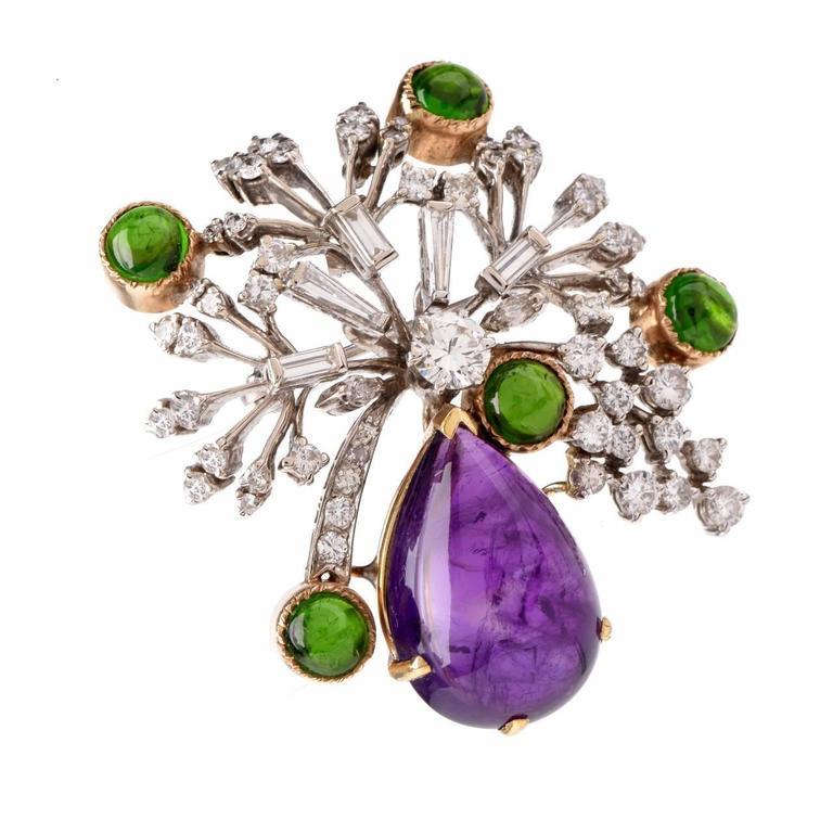 This aesthetically alluring brooch pin is crafted in a solid 14K white and yellow gold, the latter applied to colored gemstone settings. It weighs 22.5 grams and measures 2 long x 1.9