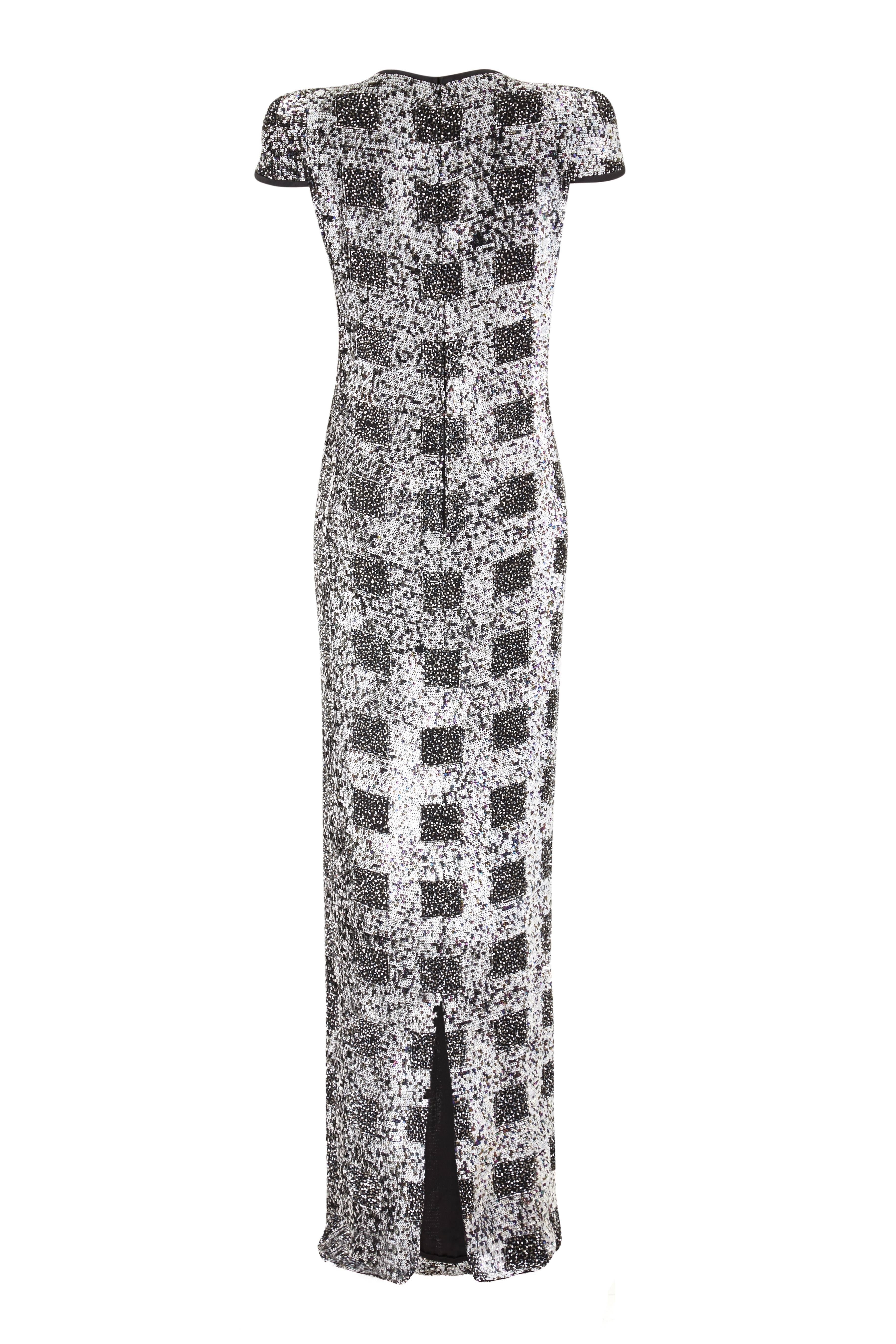 This late 1970s or early 1980s fully beaded full-length dress is from classic Italian designer Andre Laug and is of exceptional quality. This incredible dress is embellished in its entirely with monochrome and silver sequins and rocaille beadwork