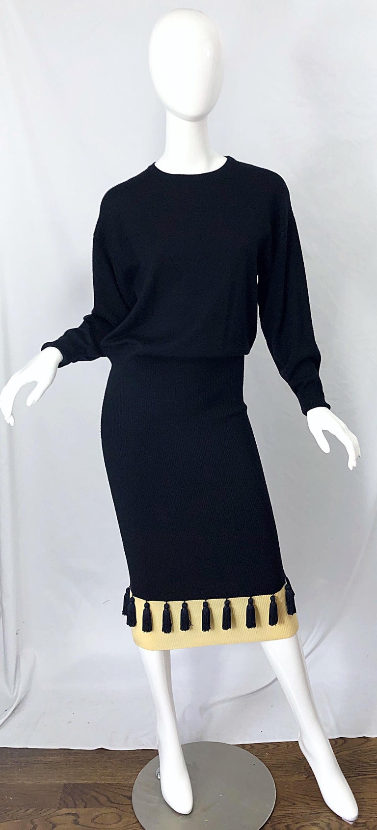 Chic vintage 80s ANGELO TARLAZZI black and ivory dolman sleeve sweater dress ! Features a luxurious soft wool that feels like cashmere. Black tassels line the hem of the dress. Simply slips over the head and stretches to fit. Slouchy fit with a drop