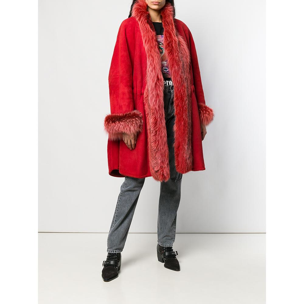 A.N.G.E.L.O. Vintage - Italy
A.N.G.E.L.O. Vintage Cult red suede shearling coat with edges trimmed in mink fur. Shawl collar, front closure with hook and internal drawstring at the waist. Long sleeves and welt pockets.

Please note, this item cannot