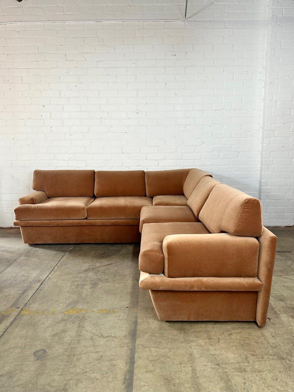Measures: W97 D100 H36 SW76 (both sides) SD23 SH21 AH24

Large L-shaped sectional with great lines all in a blush tone velvet. The seats are deep, tall and very comfortable. There fabric is overall in good condition with minor signs of wear along