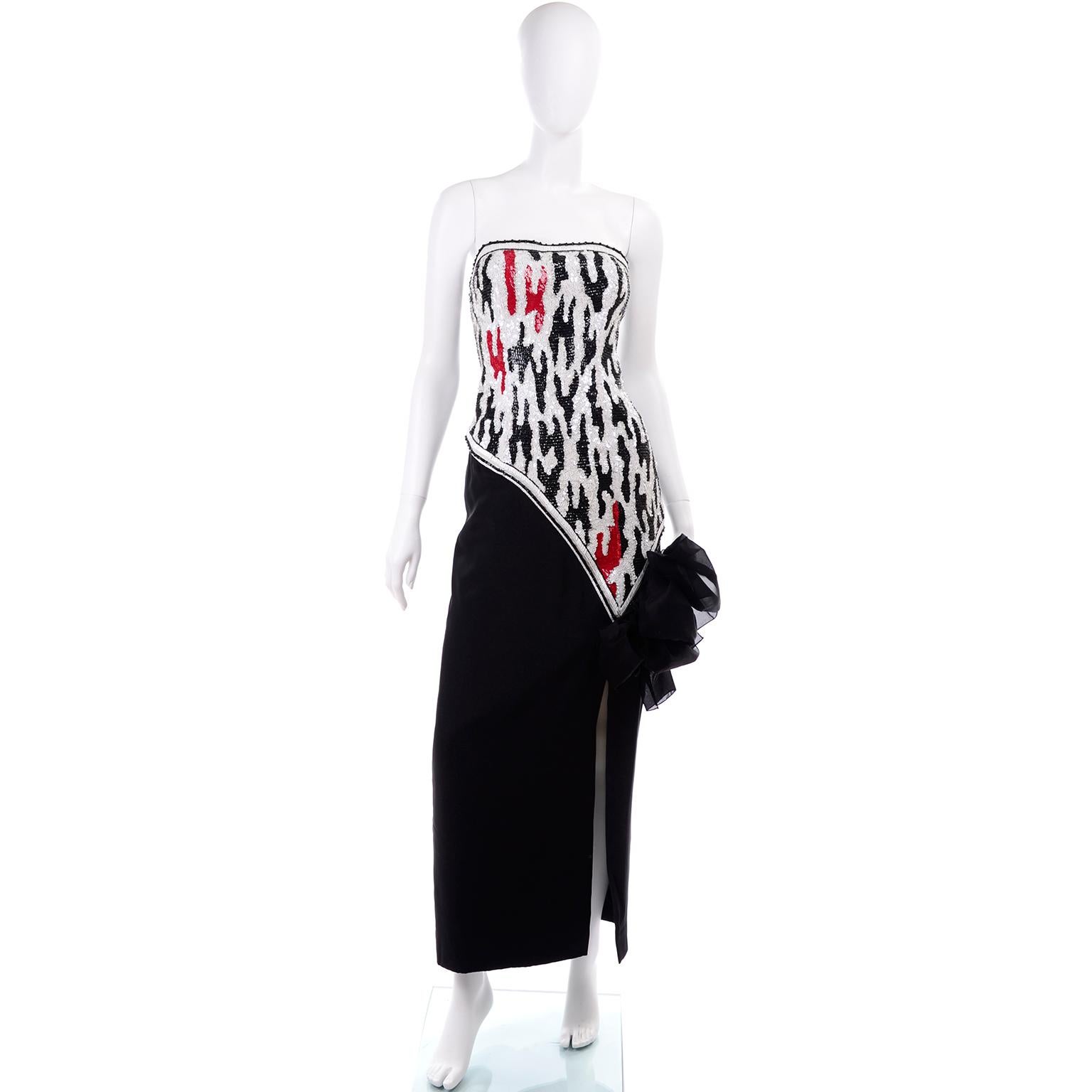This stunning vintage dress was designed by Ann Lawrence in the 1980's.  The dress has an asymmetrical bodice that is covered with red, black and red sequins in an abstract design, and it is trimmed with black and white bugle and round beads.  The