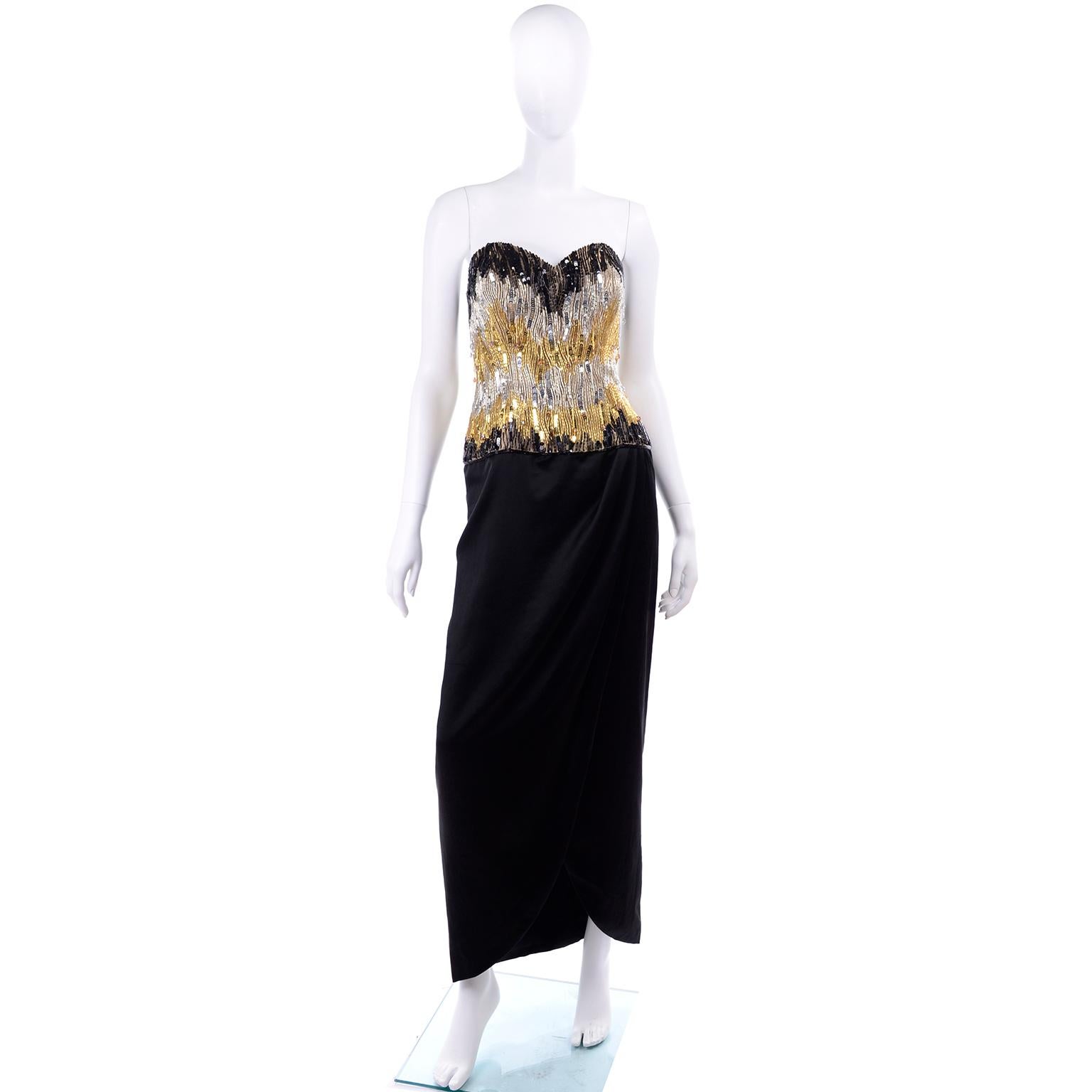 This is a couture quality vintage dress designed by Ann Lawrence in the 1980's. This stunning black, gold and silver evening gown has beads, crystals and sequins on the strapless bodice.  A really gorgeous dress with hanging beaded crystal drops and