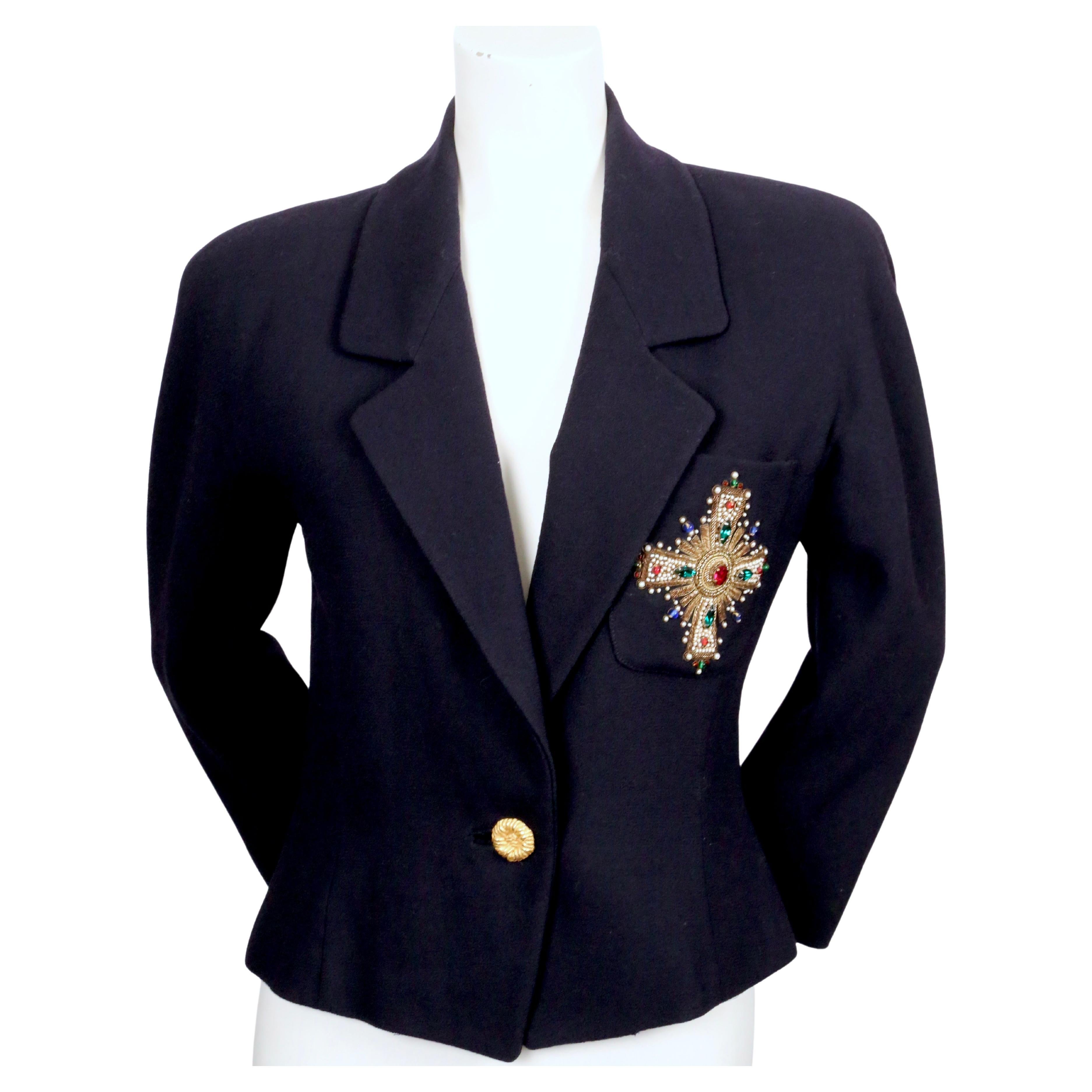 Dark navy blue wool jacket with jeweled Byzantine-style cross detail by Anne Klein dating to the late 1980's. Labeled a size 4. Approximate measurements: bust 36
