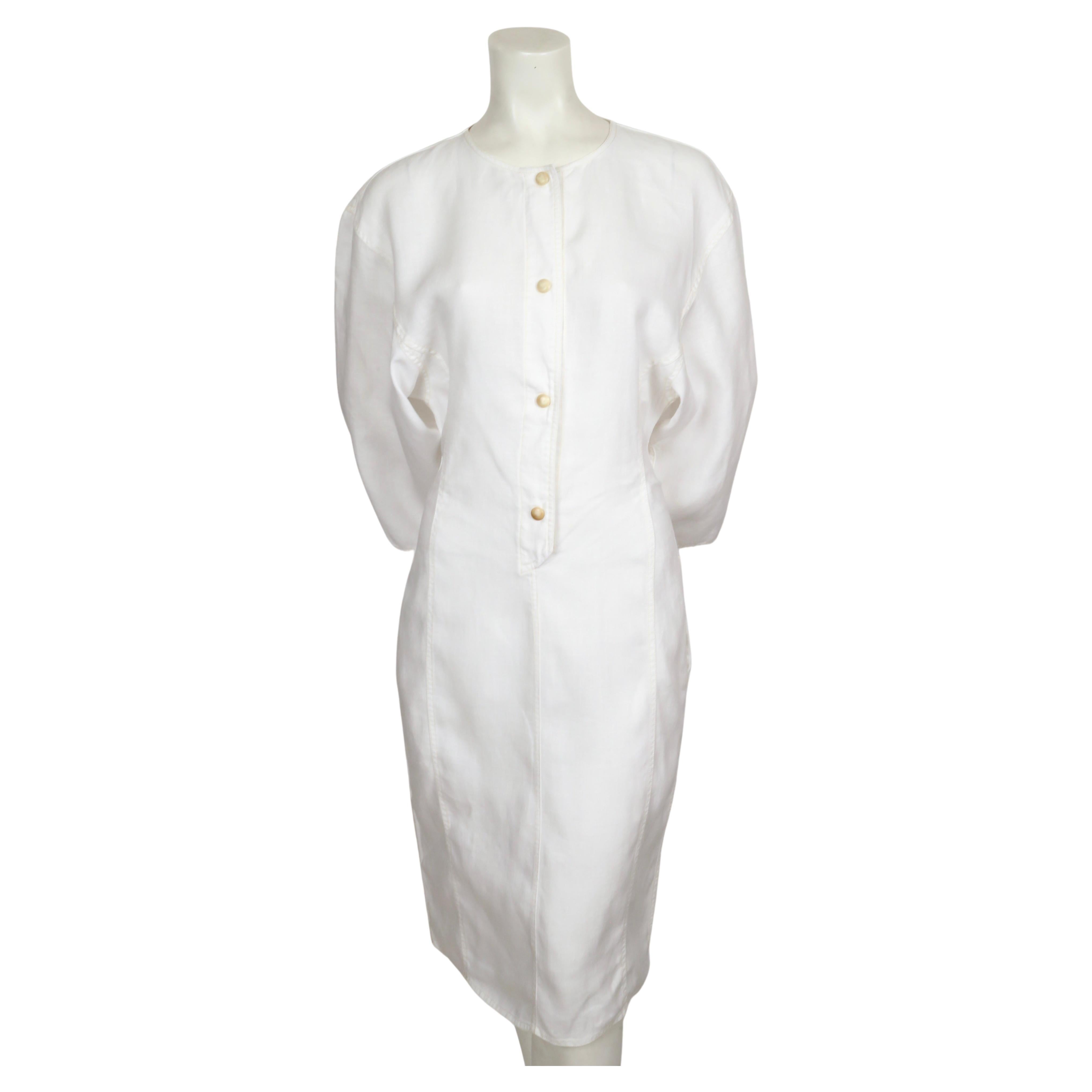 White linen dress with dolman sleeves and seamed detail designed by Anne Marie Beretta dating ot the 1980's. Dress has a very flattering, strong sculptural shape to it. Labeled a French size 40 however this fits small so it would better suit a