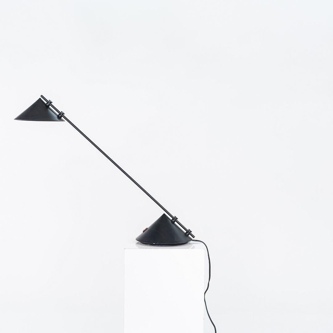 This is a Sidecar table lamp, designed and produced by Artemide of Italy in the 1980s. Constructed from a dynamic mix of metal, plastic, and painted finishes, the lamp exemplifies postmodern design through its layered use of materials and striking