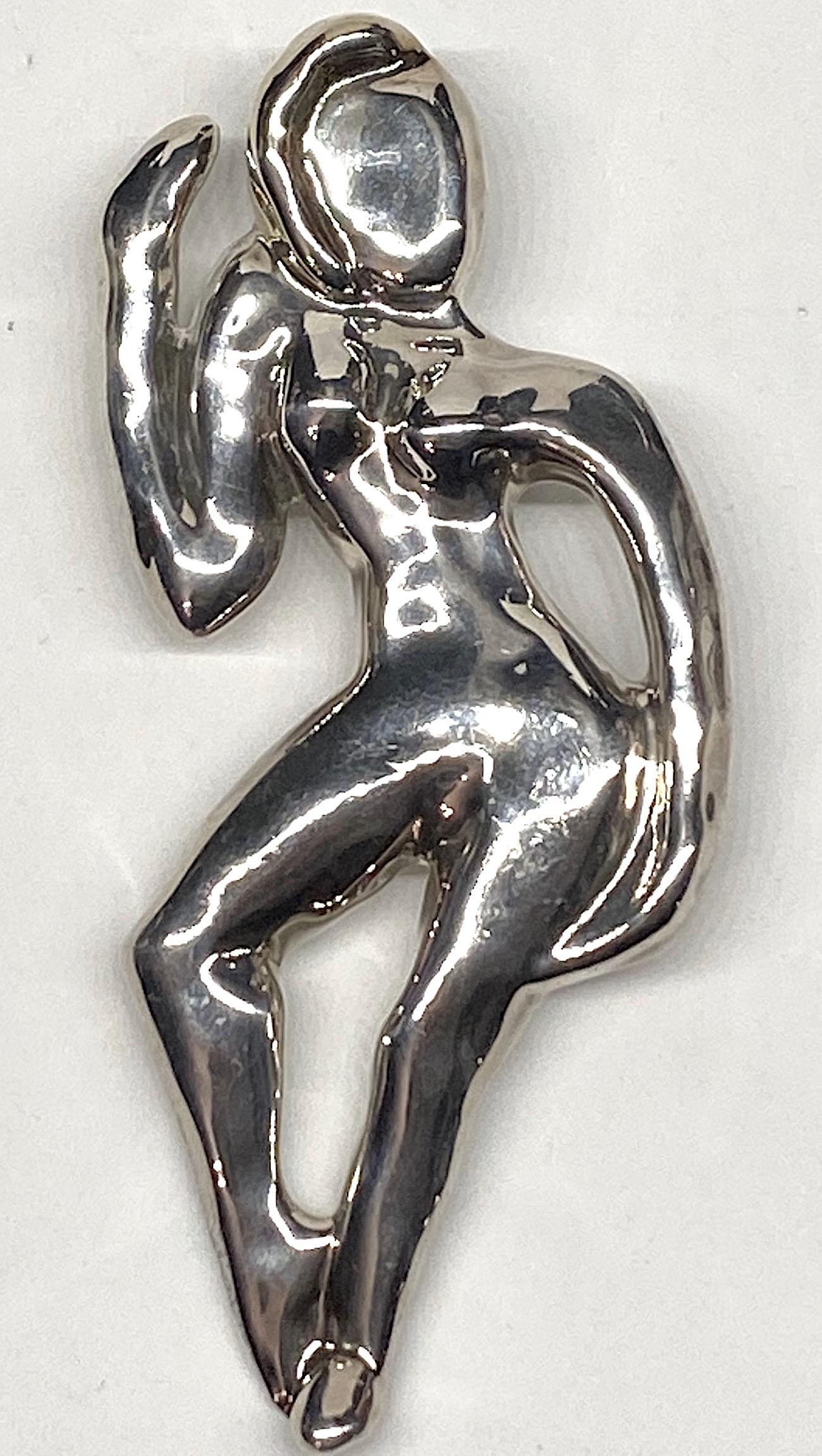 A large artist made abstract form of a woman brooch in sterling silver from the 1980s. The brooch is 2.75 inches wide, 5.25 inches high and .5 of an inch deep. Signed illegibly in script on the back by the artist and 925 for sterling silver.  The
