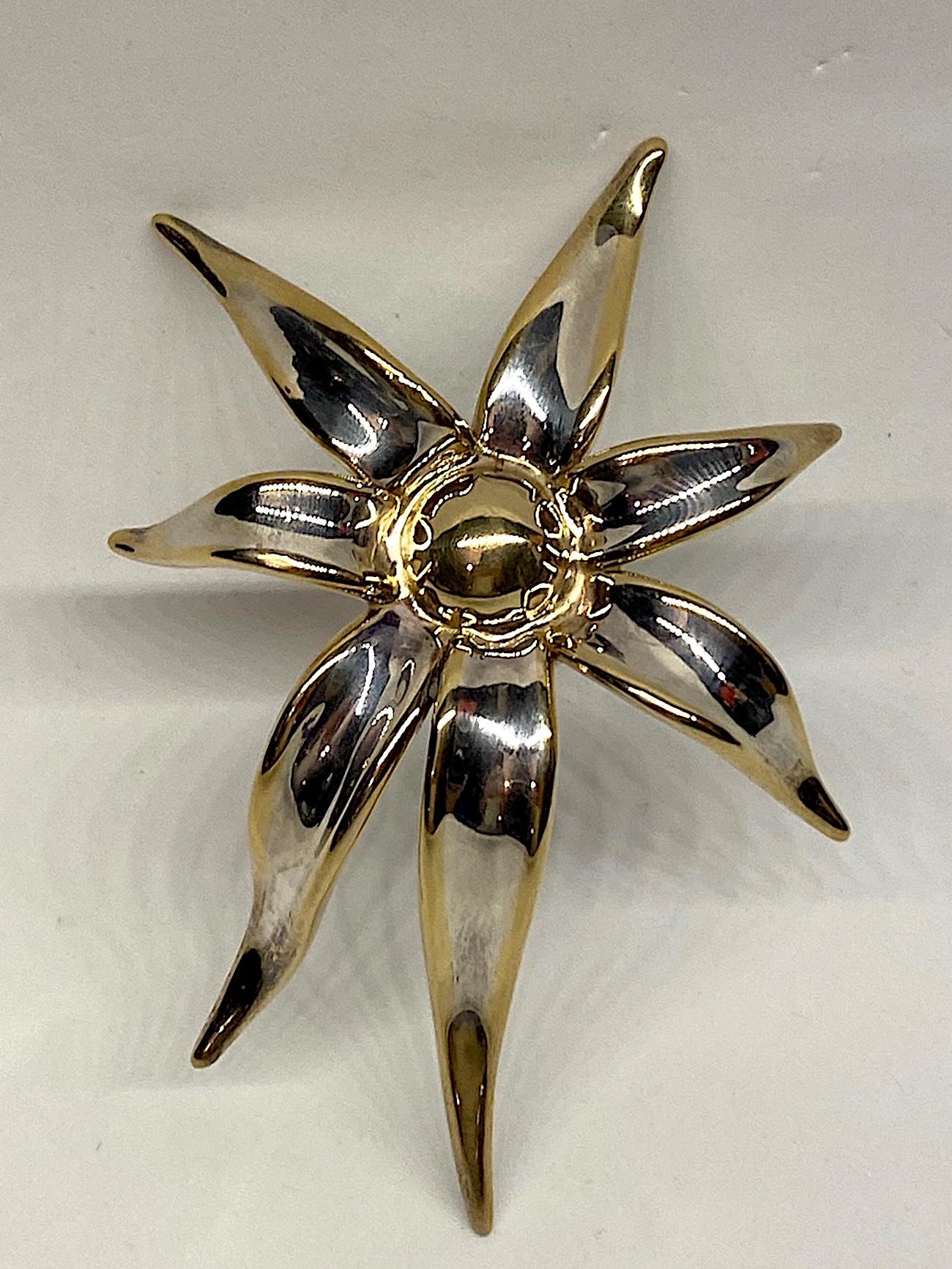 Artist made large huge seven petal flower brooch in sterling silver with gold accent from the 1980s. The brooch is 3.25 inches wide, 4.5 inches long and 1 inch high. The edges of the petals are accented in yellow gold plate as nice contrast to the