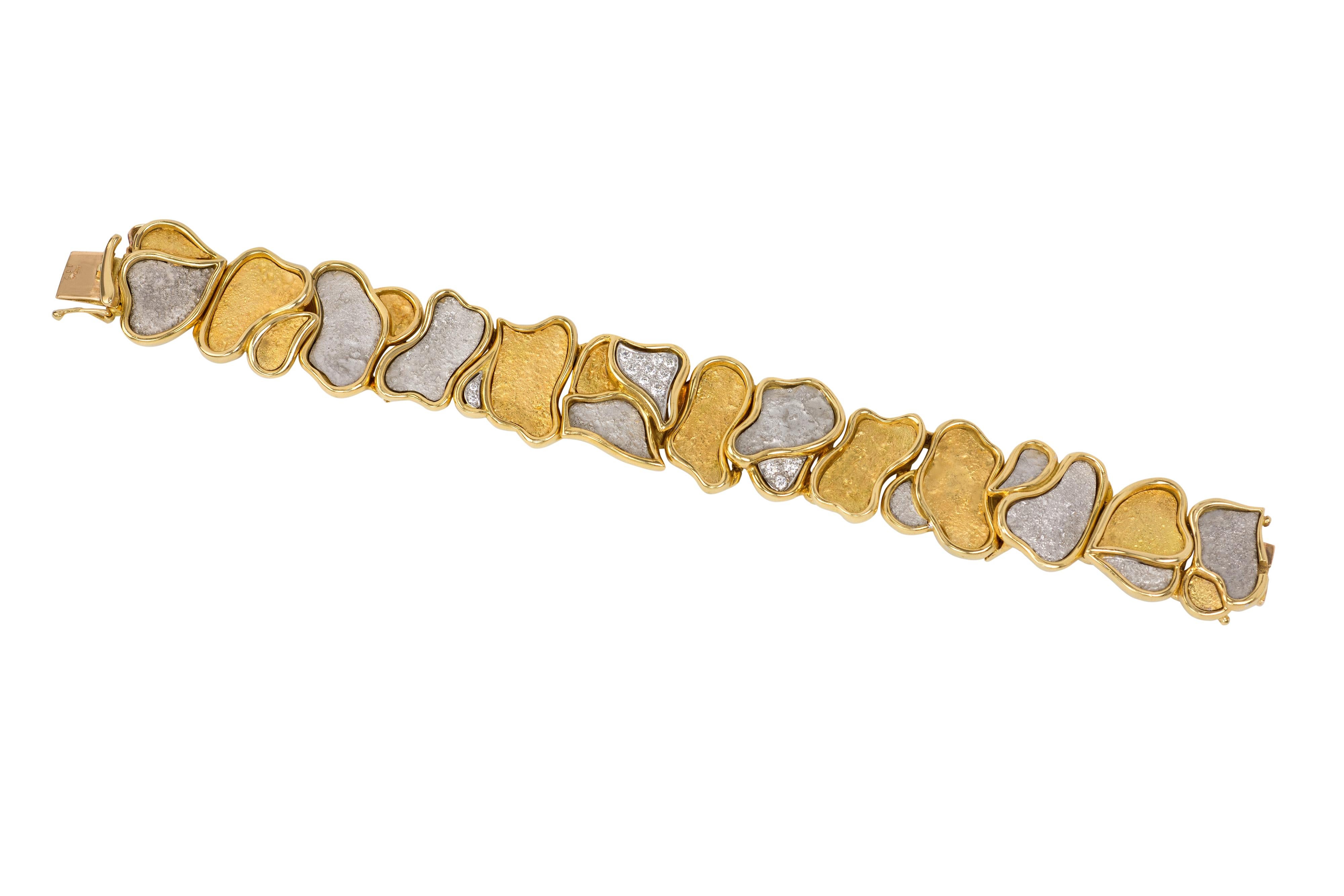 A diamond and 18 karat white and yellow gold organic design bracelet, by the highly regarded Swiss-Spanish jeweler Augustin Julia Plana, c. 1970. The bracelet is stamped design Julia-Plana  S 750. 

Julia-Plana's original and beautifully crafted