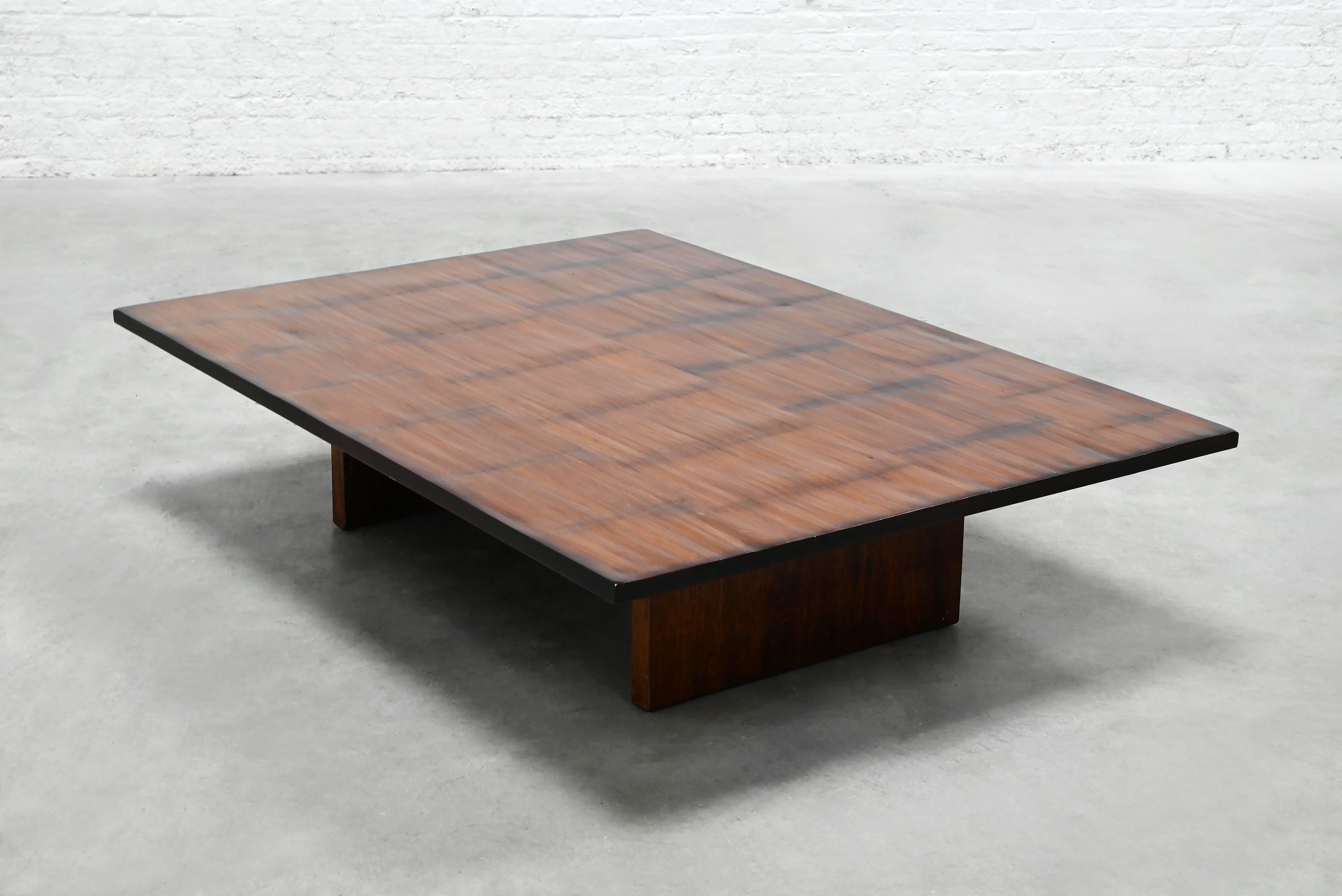 A large and elegant coffee table by interior designer Axel Vervoordt, crafted in Belgium during the 1980s. The design pairs rich, dark wood with natural bamboo slats, creating a warm, organic contrast that reflects Vervoordt’s refined,