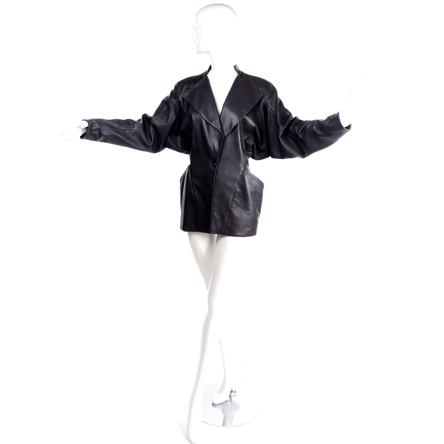 This is a stunning, very coveted vintage jacket designed by  Azzedine Alaia in the 1980's.  This black leather 80's jacket has dramatic side hip pockets and gorgeous  seam details and it snaps close in the front.  We love this coat and will hate to