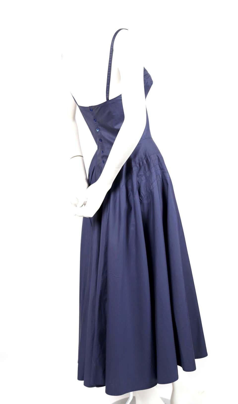 Blue, cotton bustier dress with amazing seams and full button back designed by Azzedine Alaia dating to the 1980's. Labeled a French size 38 however this would best fit a modern day French 36. Approximate measurements: bust 32.5-33