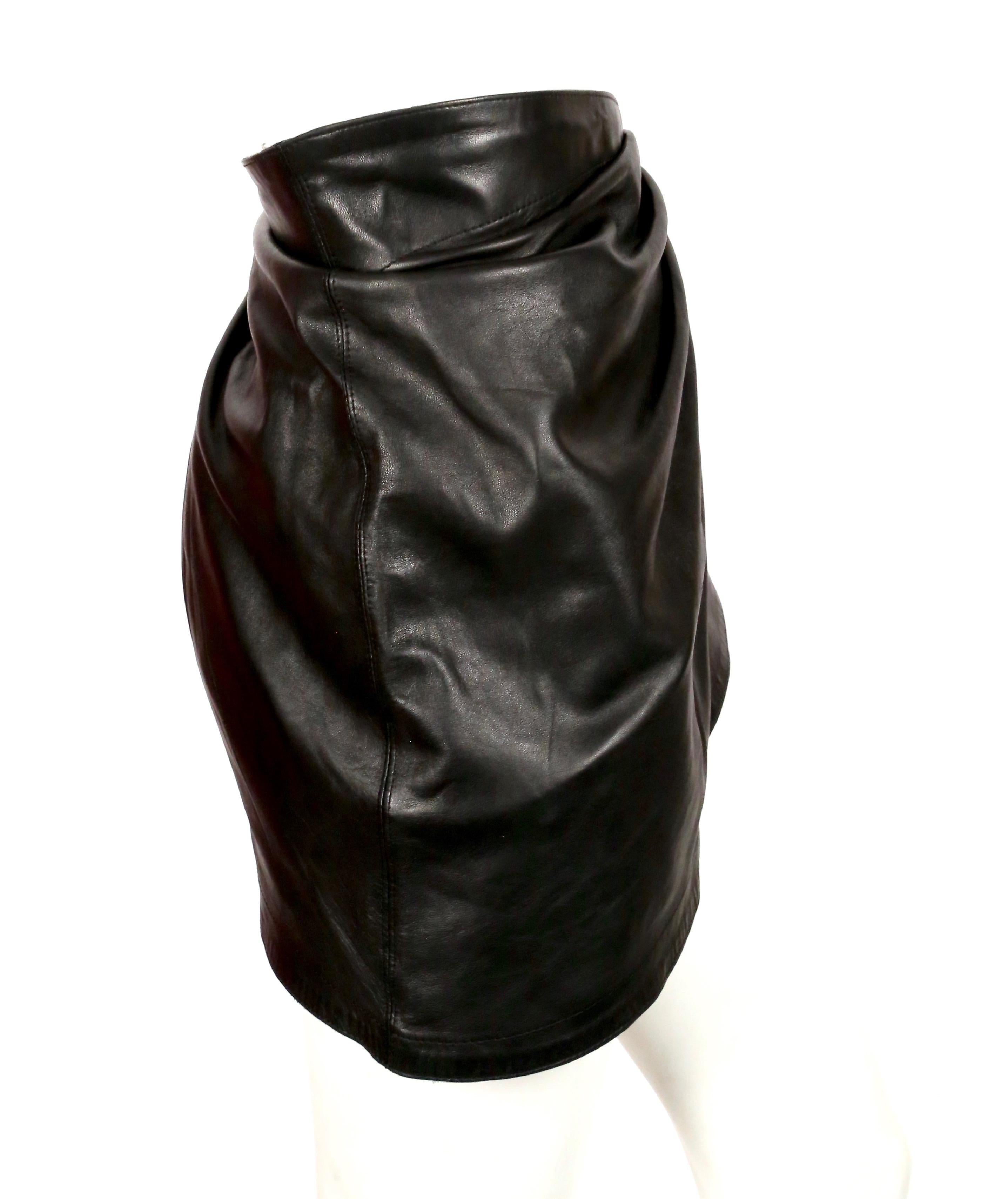 Unique lambskin mini-skirt with amazing drape and buckle detail from Azzedine Alaia dating to the 1980's. Skirt has a removable underlayer that creates additional volume. Skirt can also be worn as a belt. Size 38. It is adjustable due to the buckle