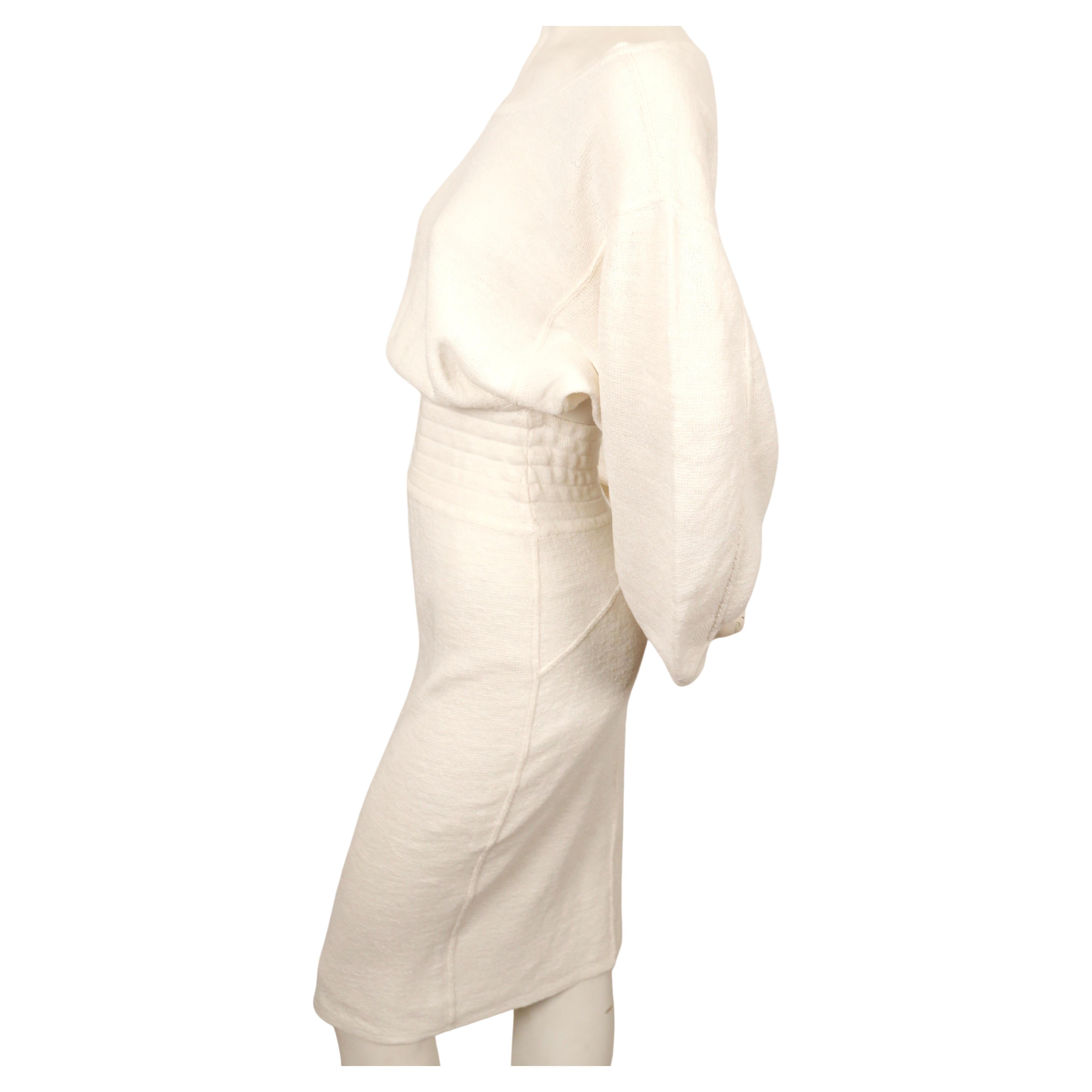 Very rare, off-white linen dress with elasticized waist and cut out back from Azzedine Alaia dating to 1985. Approximate size 'S'. Approximate measurements: drop shoulder 20