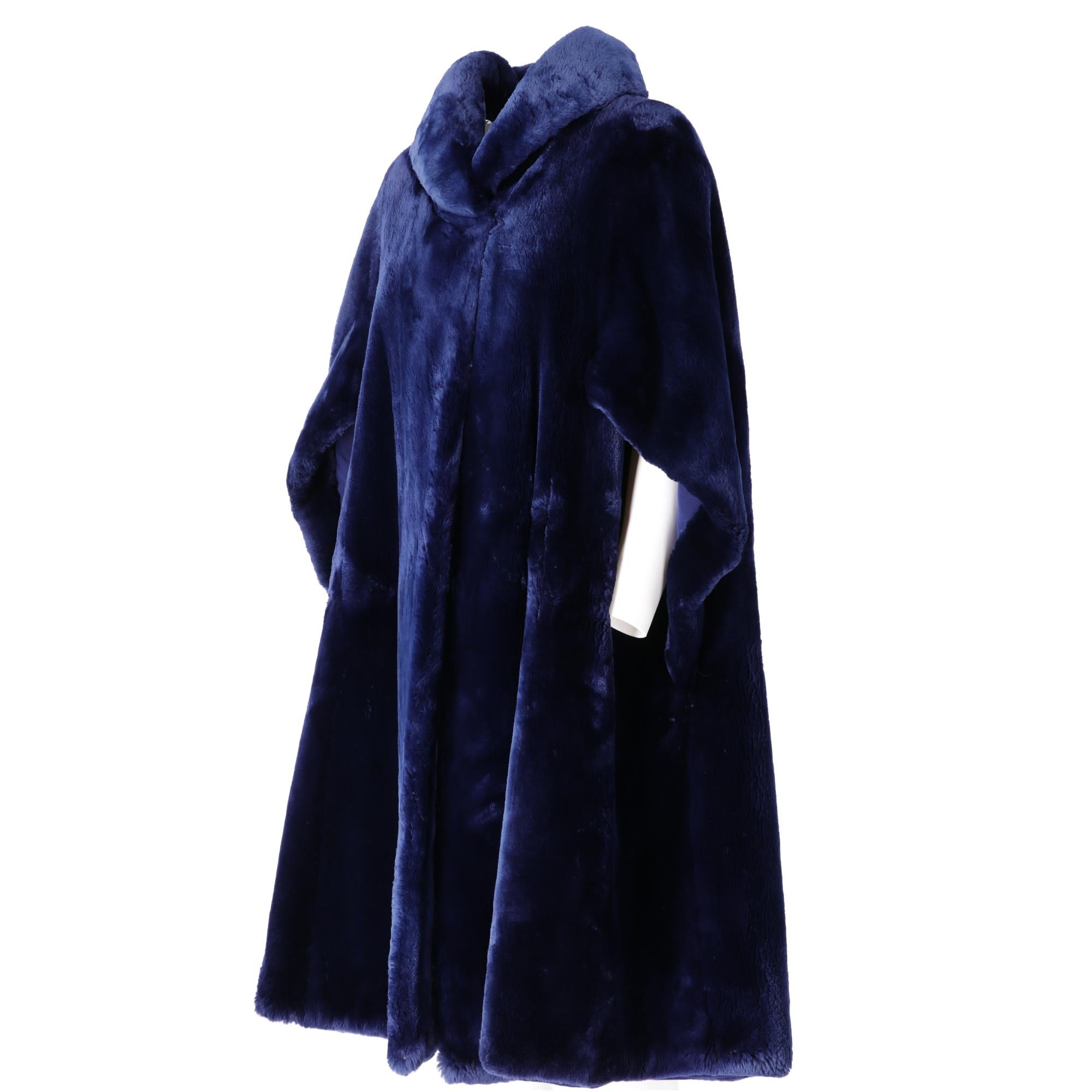 Balzani fur cape long below the knees, in real blue-tinted beaver fur, shawl collar, hidden pockets on the front in the seam, front lacing with hook and eyelet, blue fabric lining with embroidered initials, loose fit.

Please note this item cannot