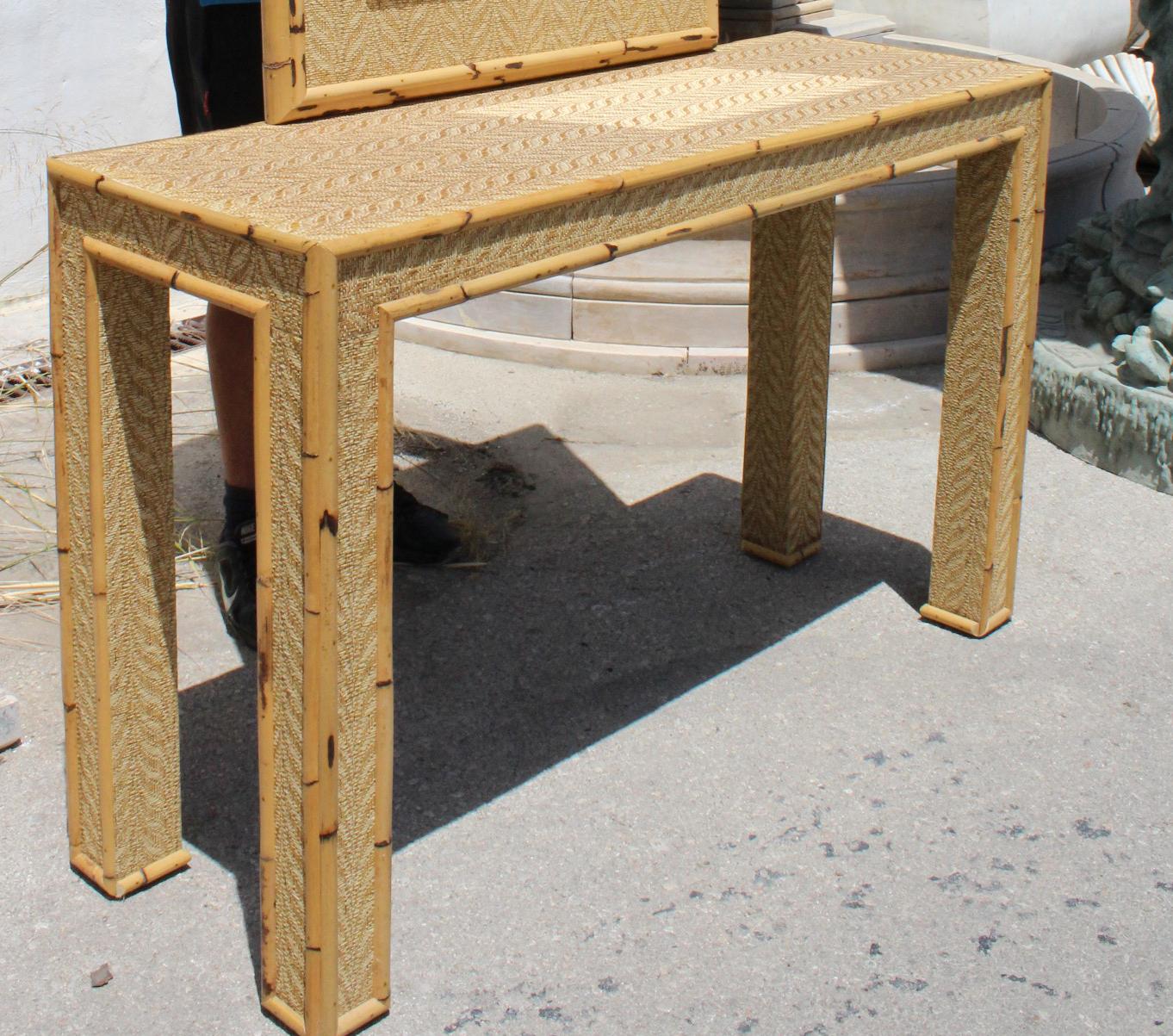 1980s bamboo and rattan console table with mirror set. 

Mirror measurements: 105 x 73cm.
 