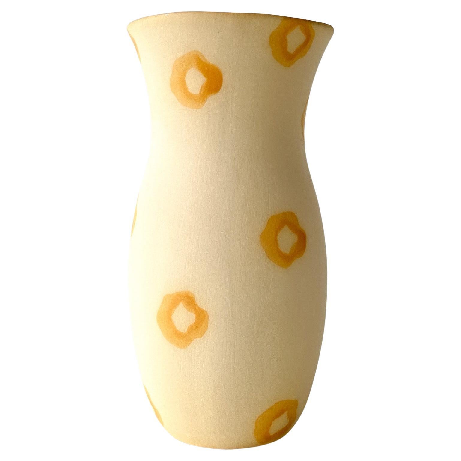 Circa 1980s Barbara Eigen ceramic postmodern vase. Pale yellow matte glaze with golden yellow gloss circles and glazed interior. 

About the artist: 
Eigen studied ceramics at the Boston Museum of Fine Arts School and Alfred University. A professor