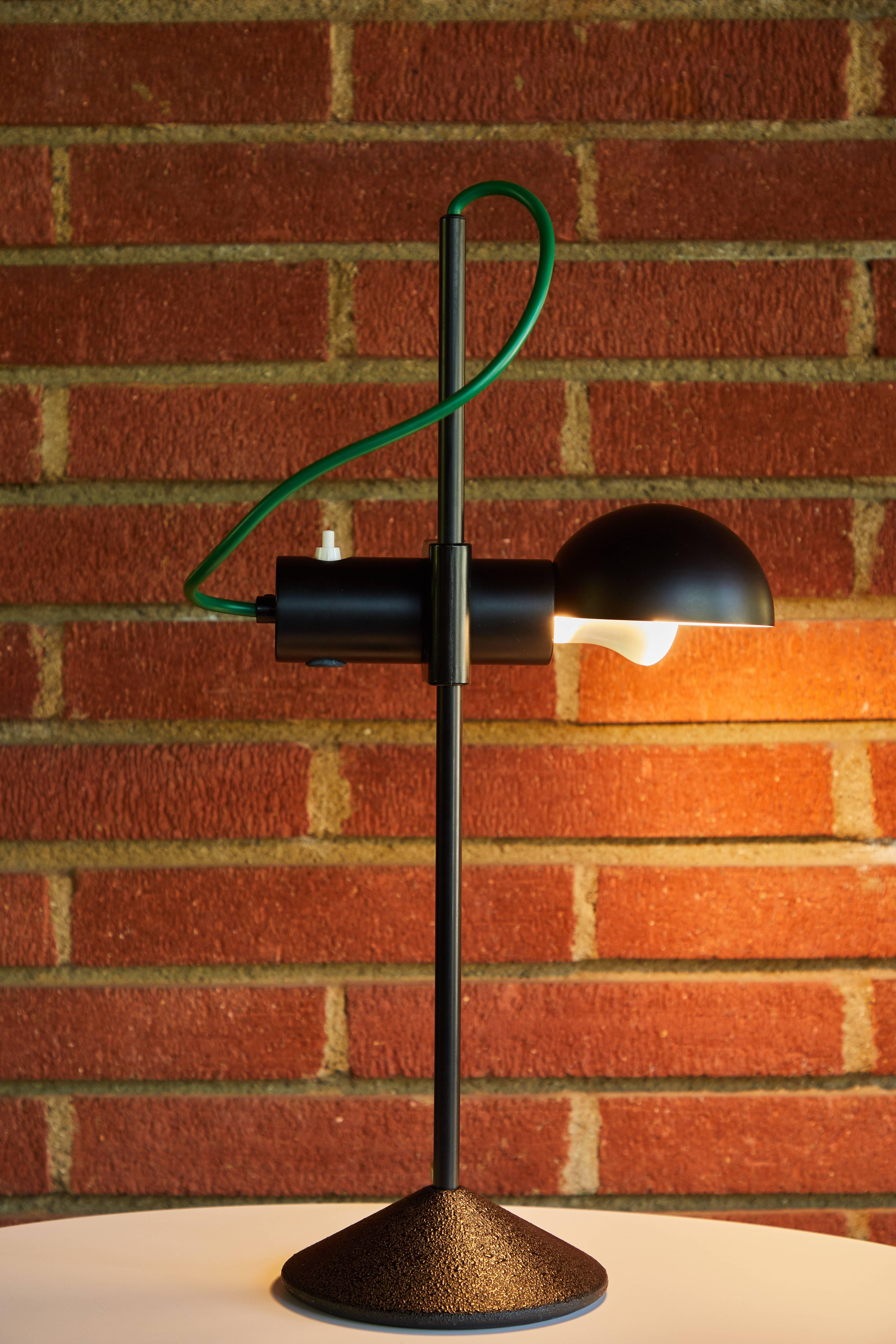 1980s Barbieri & Marianelli table lamp for Tronconi. Executed in black matte metal, black plastic, and green cord. Shade rotates left and right. On/off switch on shade. A surprisingly bold yet refined Italian design, especially for the early 1980s.