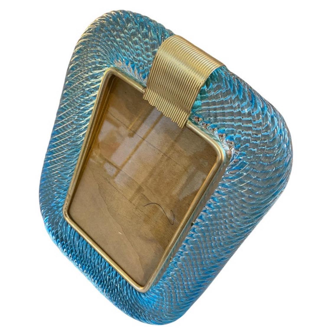 A light blue Murano glass picture frame designed and manufactured in Venice in the style of Barovier in lovely condition. The vintage photo frame is a beautiful and elegant piece of decor that is perfect for displaying your favorite memories in