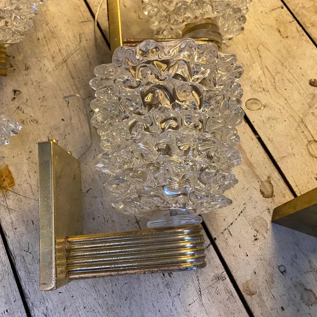 A pair of wall lights designed and manufactured in Italy in the style of Barovier, that invented this particular glass processing named Rostrato characterized by large light-reflecting points, obtained with a particular technical expedient, brass
