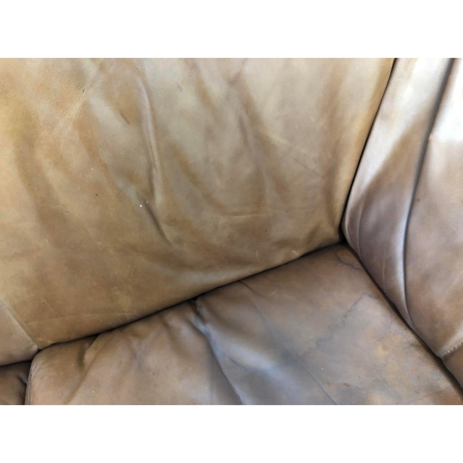 A Le Stelle B&B Italia 1980s leather sofa. Designed by Mario Bellini. Bring comfort, luxury and style into your sitting room. The arms are flared with a slanted back for lounging. Distress leather is in good condition with minor imperfections. One
