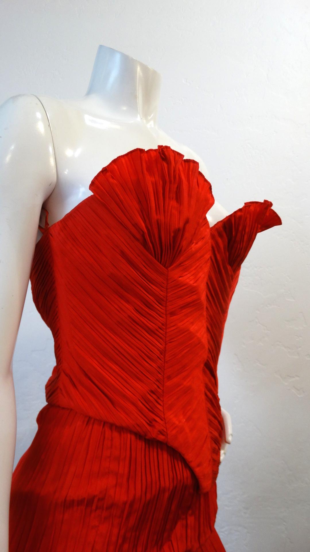 Make A Statement With This Amazing Piece! Circa 1980s, this Bernard Perris couture silk crepe bustier is a beautiful red color and features intricate asymmetrical pleating throughout. The cups on the bustier are high standing and mimic a shell like