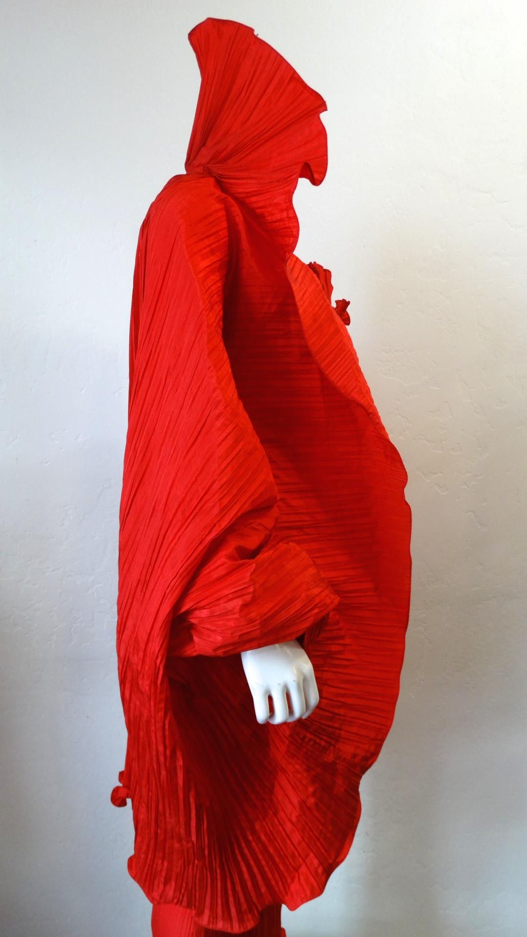 Make A Statement With This Amazing Piece! Circa late 1980s, this incredible Bernard Perris vibrant red pleated silk crepe cape features an extravagant Elizabethan high standing collar and a ruffled hem all throughout. The high standing collar