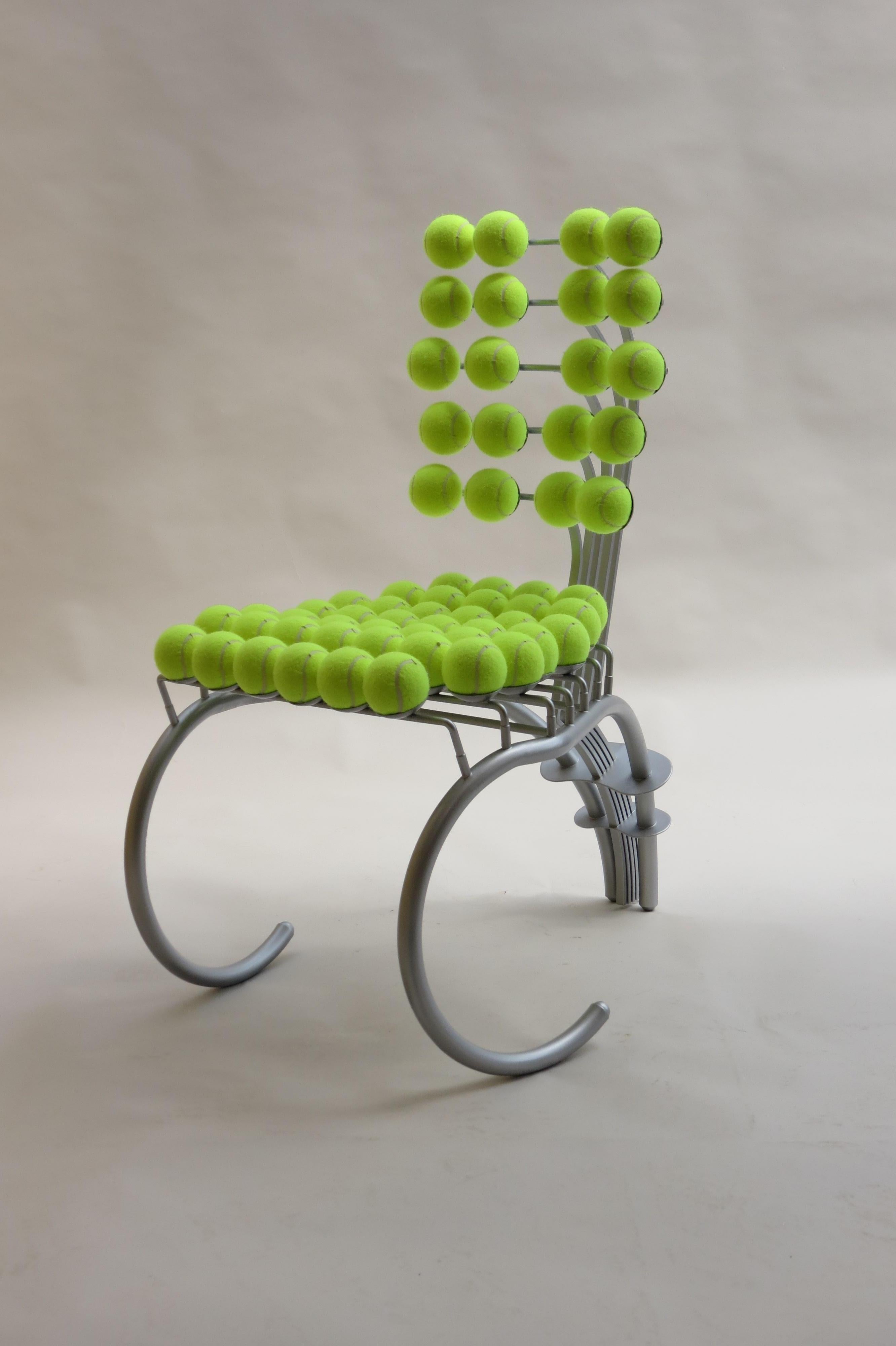 A bespoke chair made from steel and tennis balls. Believed to have been removed from Wimbledon Tennis Club when it was refurbished.  The chair is very well made and has a five leaf spring action to the back.  The tennis balls have been replaced and
