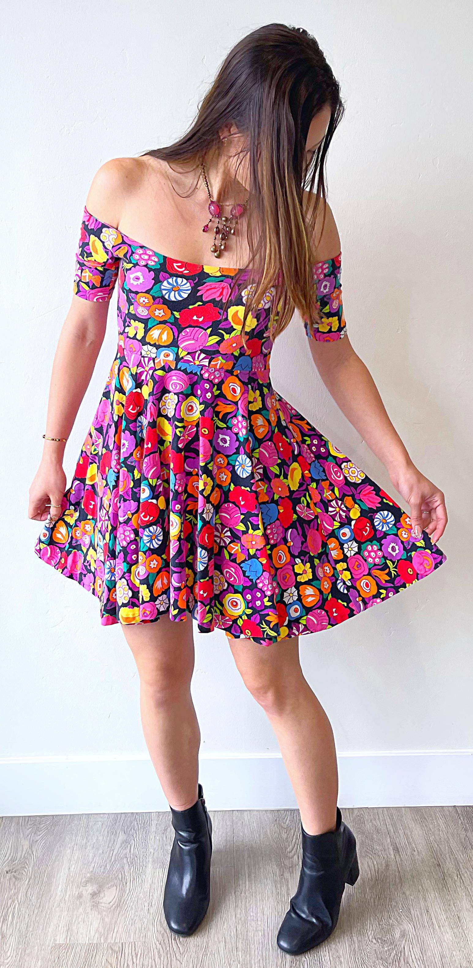 Rare early BETSEY JOHNSON Punk Label 1980s Vintage brightly colored flower print off the shoulder mini dress ! Features bright colors of hot pink, orange, fuchsia, purple, green, yellow, blue, red, black and white throughout. Can also be worn with