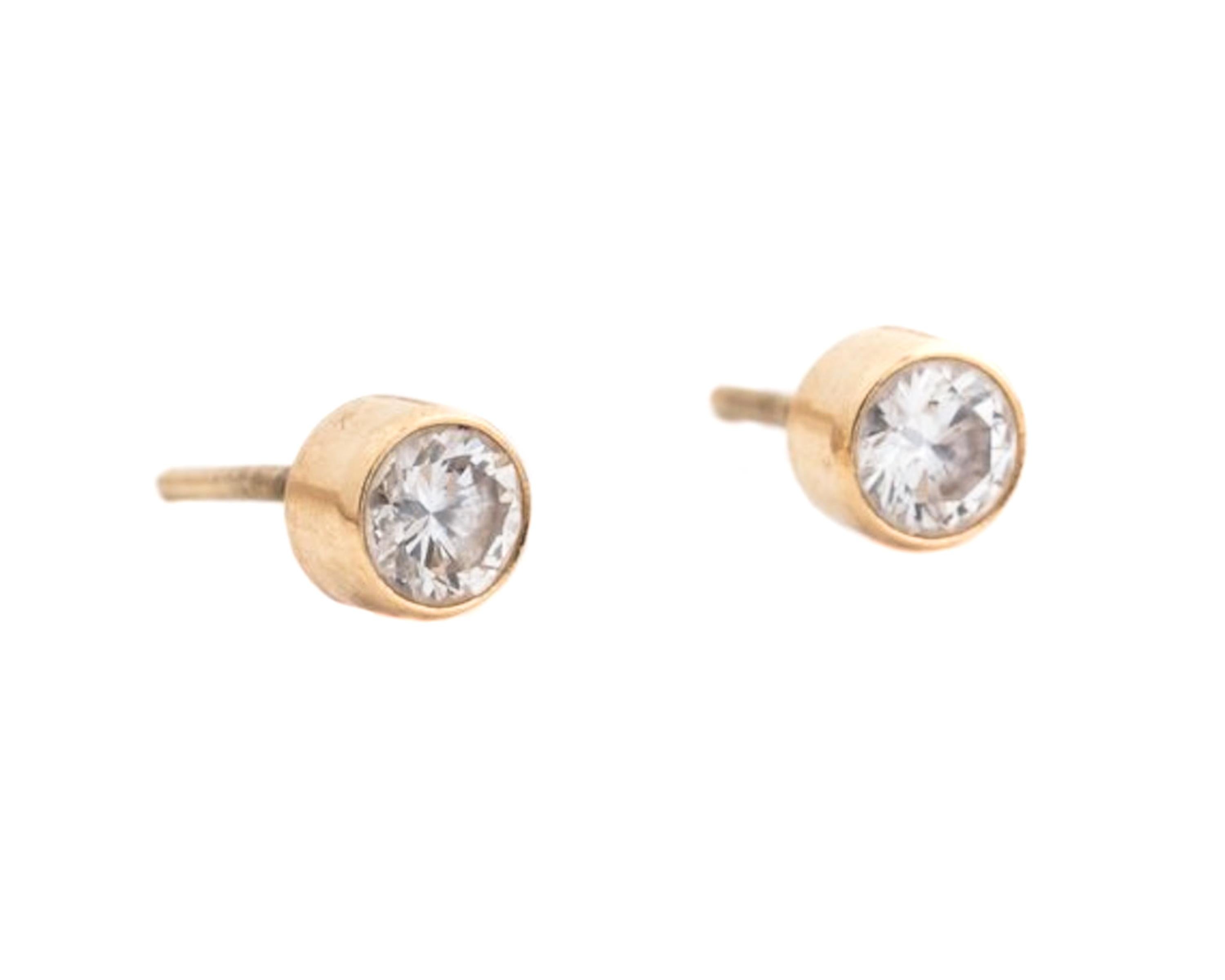 1980s Diamond Earrings, Screw Back - 14k Yellow Gold, Diamonds

The Round Brilliant Diamonds are surrounded by a 14k yellow gold bezel frame.
The earrings measure 4.5 millimeters across. 
The backs are not included in the photos, but are included
